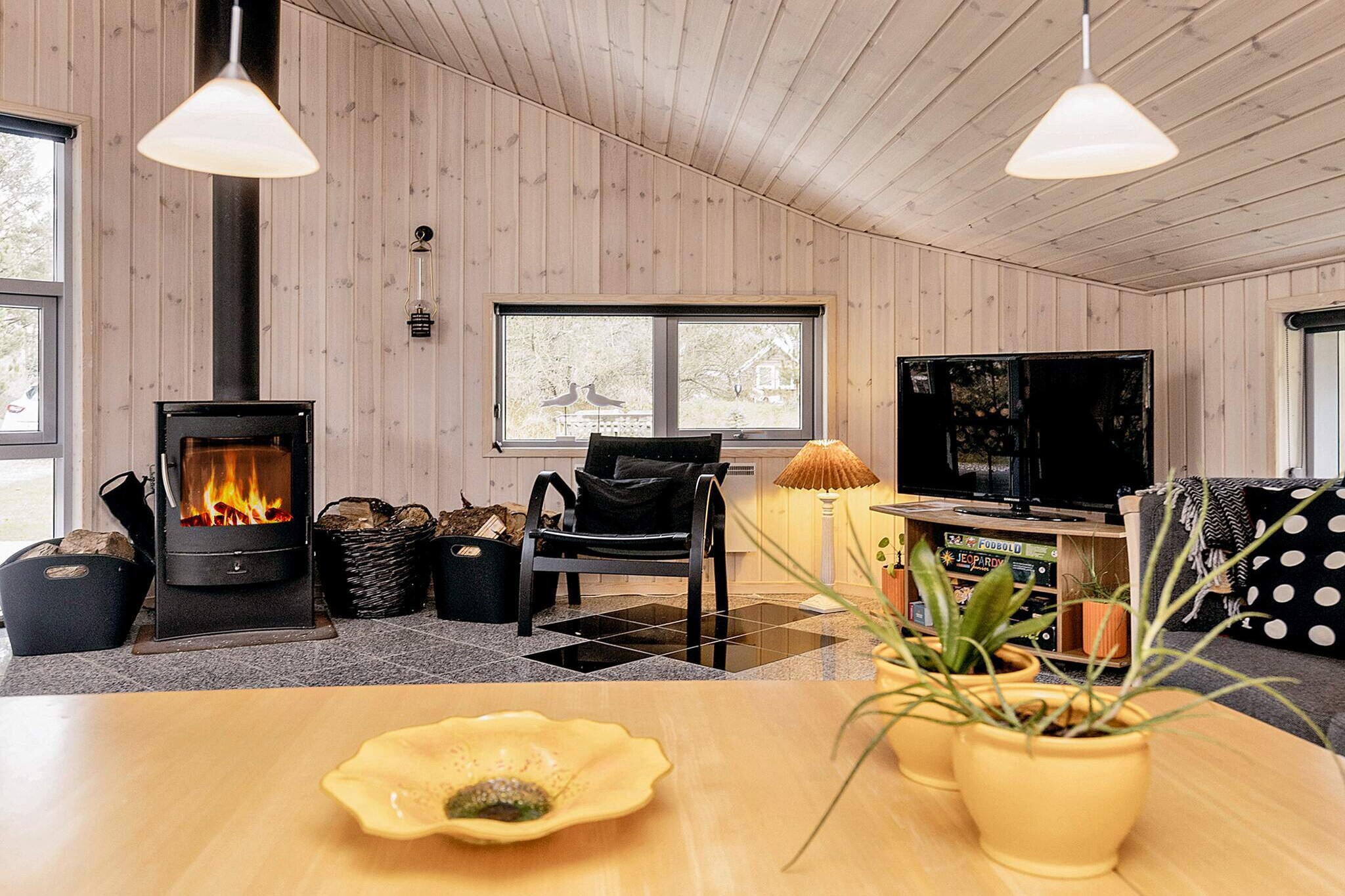 open kitchen(cooker(electric), hood, coffee machine, microwave, dishwasher, fridge(+ freezer), washing machine), Living/bed room(DVD player, radio), bedroom(double bed), bedroom(double bed), bedroom(4x bunk bed), bathroom(floor heating)(bathtub or shower, washbasin, hip bath, toilet), bathroom(floor heating)(bathtub or shower, washbasin, toilet), heating(electric), terrace(roofed), BBQ, air to air heatpump