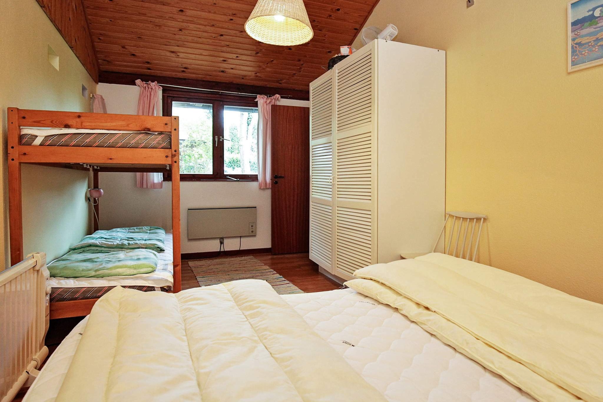 open kitchen(cooker(electric), hood, coffee machine, fridge(+ freezer)), Living/bed room(TV(cable, danish TV channels (DR1 and TV2)), radio, CD player, stereo unit), bedroom(double bed, 2x bunk bed), bedroom(2x bunk bed), bathroom(bathtub or shower, washbasin, toilet), heating(electric), terrace, BBQ