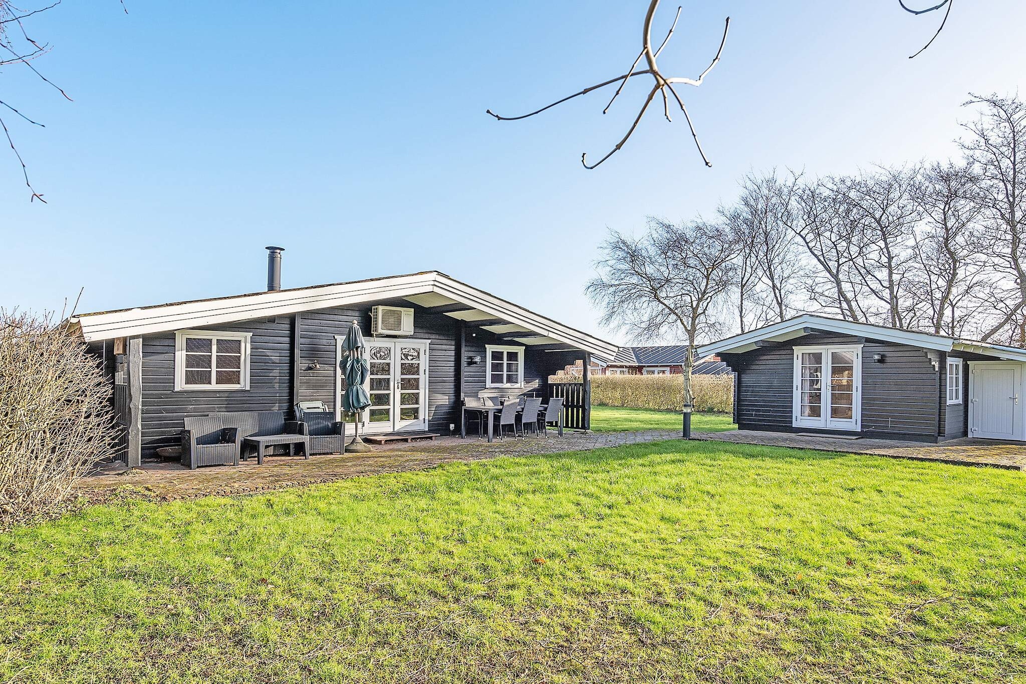 Annex: (4x single bed)\n\nInternet Access DSL, open kitchen(cooker(electric), hood, coffee machine, dishwasher, fridge(+ freezer)), Living/bed room(TV(cable, german television channels, danish TV channels (DR1 and TV2)), radio), bedroom(double bed), bedroom(2x single bed), bathroom(bathtub or shower, washbasin, toilet), heating(electric), terrace, terrace(roofed), air to air heatpump