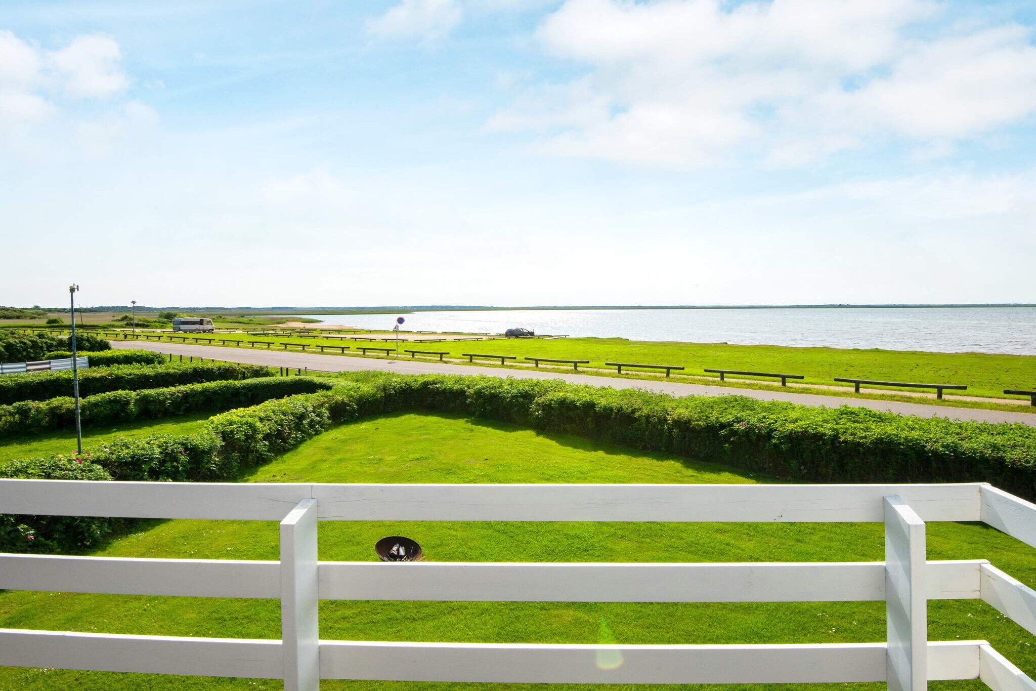Holiday cottage in the 1st row directly adjacent to one of Europe's best windsurfing and kite spots. Modernised in 2004. Interesting house with an extraordinary location on the 700 m² large plot in the 1st row down to the fjord. No letting to youth groups. The 33 m wide lawn towards the fjord invites to many activities such as ball games, badminton, croquet, etc. From the lawn you can follow the life on the beach and in the water.  After a good day with lots of activities and great experiences you can enjoy the unique location of the house - the view of the countryside and beach at a distance of approx. 50 m from the water's edge. The living room on the 1st floor has a fantastic view of the fjord from the leather furniture. In the living room there are 2 alcoves, where you can take a rest after a busy day. On the 1st floor there is a sliding door from the living room to a 14 m² partly covered balcony from where you can enjoy the sun set into the water while eating dinner or enjoying a drink on the balcony. On the ground floor there is underfloor heating in the kitchen-dining area, bathroom and sauna. In the large kitchen-dining area there are sliding doors to a large west facing terrace and garden. From the dining table in the kitchen-family room you have views of the water. At the front of the house there is a large, east-faced terrace where you can enjoy your breakfast. After a long day you can relax in the whirlpool or sauna.A refundable deposit might be charged closer to your check-in date. The security deposit ensures a smooth stay and covers any additional services or consumption charges.This deposit covers utilities consumed during your stay and any additional services that may be taken.The final amount will be adjusted based on actual meter readings, actual usage of extra services, and any remaining balance will be refunded within 21 days after checkout.This deposit simply acts as a prepayment for charges that  you would anyways pay for, ensuring a seamless stay and check-out experience.