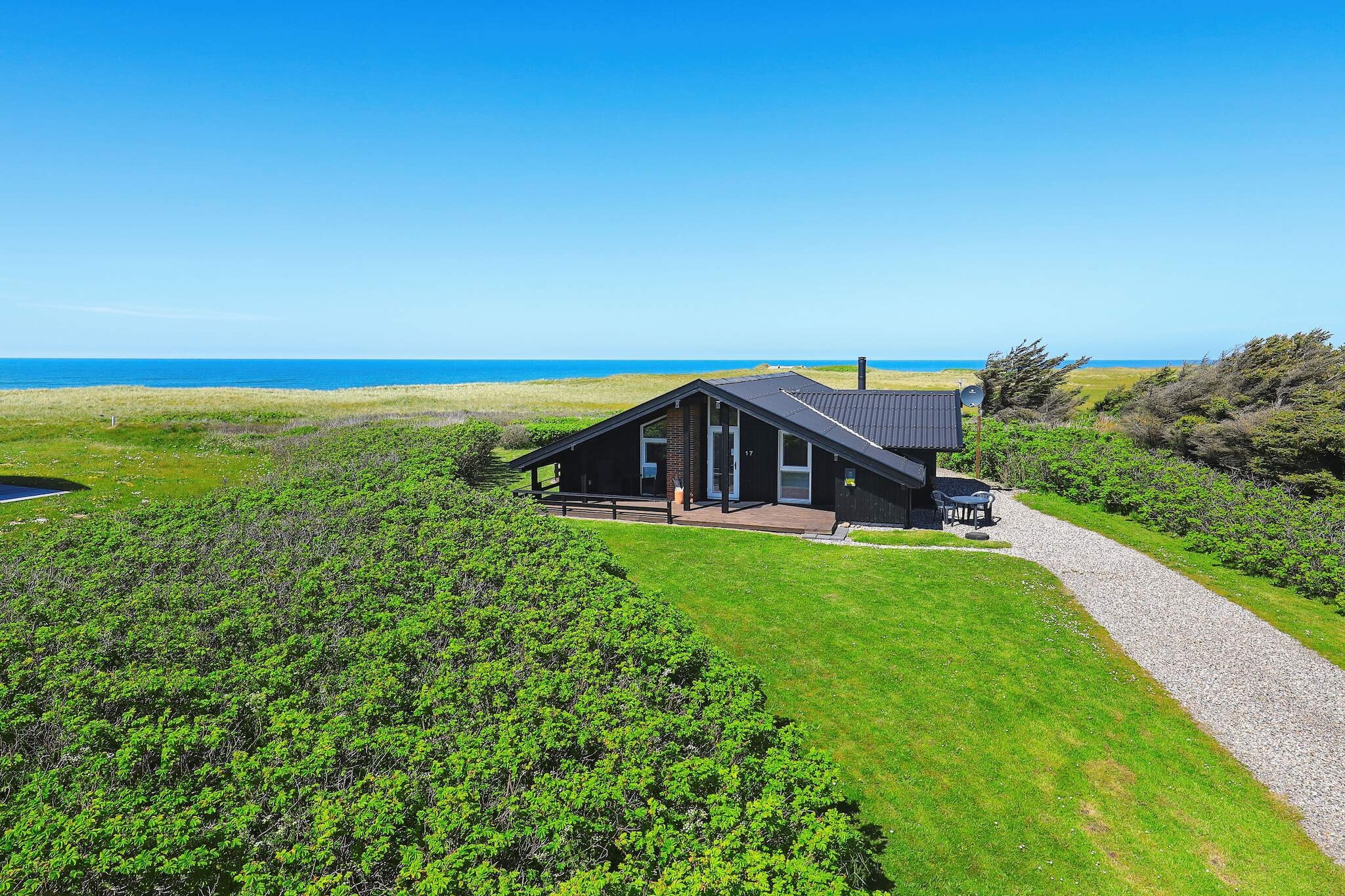 Interesting holiday cottage located on a natural plot close to the ocean and beach with panoramic views of the ocean from both living room, kitchen and plot. The house was renovated in 2008 and is not very tasteful in a modern, Danish style with emphasis on lighting and space. Open concept kitchen and living room, 3 good bedrooms, bathroom with sauna, whirlpool and underfloor heating. Wooden floors throughout except in the bathroom. Both open and covered terrace. Free admitrance to water park.A refundable deposit might be charged closer to your check-in date. The security deposit ensures a smooth stay and covers any additional services or consumption charges.This deposit covers utilities consumed during your stay and any additional services that may be taken.The final amount will be adjusted based on actual meter readings, actual usage of extra services, and any remaining balance will be refunded within 21 days after checkout.This deposit simply acts as a prepayment for charges that  you would anyways pay for, ensuring a seamless stay and check-out experience.