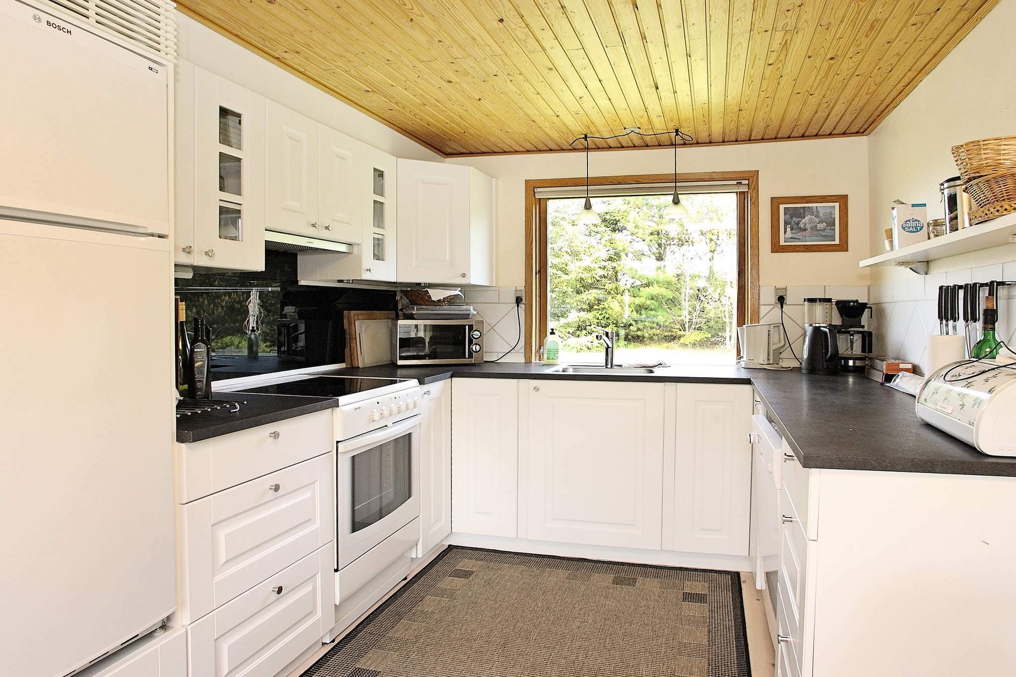 open kitchen(cooker(electric), hood, coffee machine, microwave, dishwasher, fridge-freezer), Living/bed room(TV(cable, german television channels, danish TV channels (DR1 and TV2)), DVD player, CD player, stereo unit), bedroom(double bed), bedroom(double bed), bedroom(2x single bed), bedroom(2x bunk bed), bathroom(floor heating)(tumble dryer, bathtub or shower, washbasin, toilet, washing machine), bathroom(washbasin, toilet), Bubble bath(indoor, heated, 2 persons), heating(electric), terrace, BBQ, play equipment, football goal, air to air heatpump