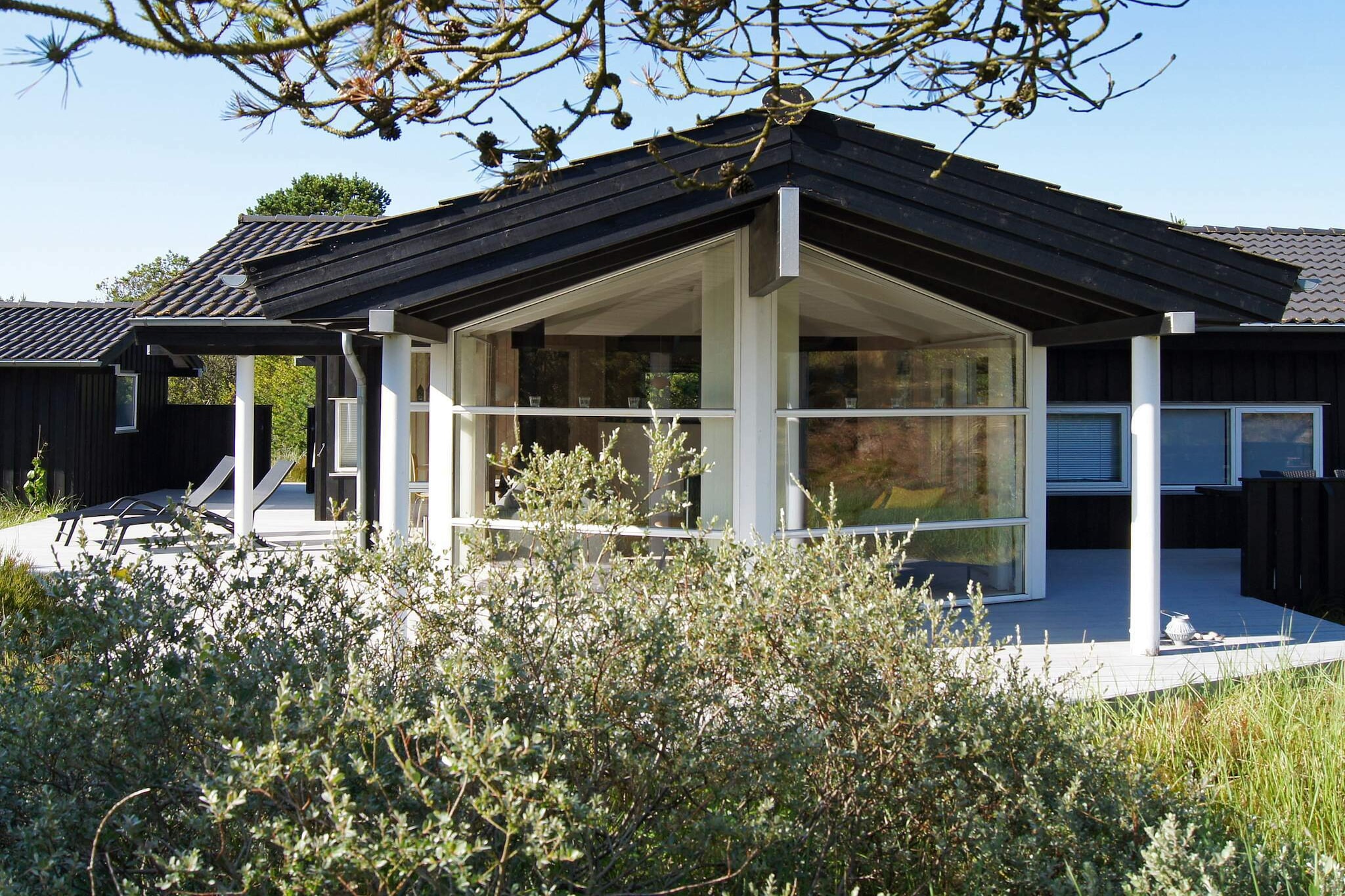 A holiday cottage located at the end of a cul-de-sac on a natural plot of 1500 m², with sand dunes as its closest "neighbour". Listen to the murmur of the sea from the large terrace, which is partly covered for those late summer nights. There is a sandbox on the plot. there is a well-equipped kitchen in the house. Open fires are not permitted on the grounds. there is an electric car charger available in the carport by the summer house.A refundable deposit might be charged closer to your check-in date. The security deposit ensures a smooth stay and covers any additional services or consumption charges.This deposit covers utilities consumed during your stay and any additional services that may be taken.The final amount will be adjusted based on actual meter readings, actual usage of extra services, and any remaining balance will be refunded within 21 days after checkout.This deposit simply acts as a prepayment for charges that  you would anyways pay for, ensuring a seamless stay and check-out experience.