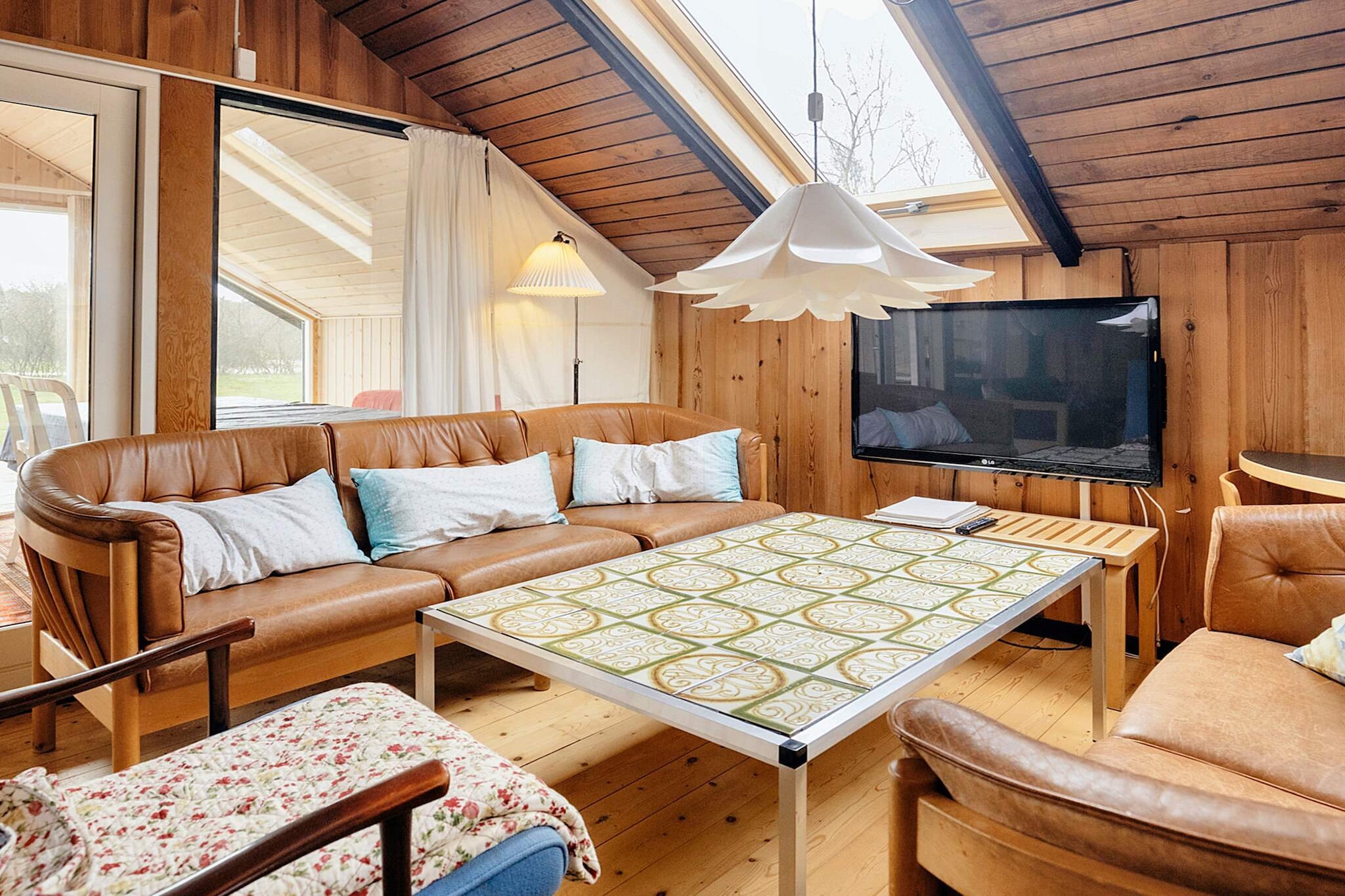 Personally furnished cottage located on a large lawn in scenic, quiet surroundings by Slettestrand. The house was built in 1969, modernized in 1990 and contains a living room / kitchen in open connection, three bedrooms, bathroom with shower and underfloor heating and sauna. The decor is personal in the familiar, slightly rustic, Danish cottage style with dining area by the kitchen and living area with sofa arrangement. There is a terrace to the east, south and west, where it is easy to find a good corner for sunbathing and evening fun around the grill. Shelter is also there, as part of the terrace is sheltered from the westerly wind. The plot is a flat lawn surrounded by planting. Here there are good opportunities for ball games or other play with the children and there are both sandbox and swings as well as football goals. With approx. 500 m to the beach at Slettestrand, one of the northern west coast's fine bathing beaches. In addition, the area has a scenic hinterland with large dune plantations that invite to hiking and biking, mushroom hunting, bird studies and much more. Starting and ending in Slettestrand, there is an excellent mountain bike track of 17 km. The nearest major seaside resort is Blokhus with a cozy environment with several good restaurants and cafes, opportunities for shopping, supermarkets, tourist information, golf course, mini golf, equestrian center m.m. as well as several working art workshops such as. galleries and potters.