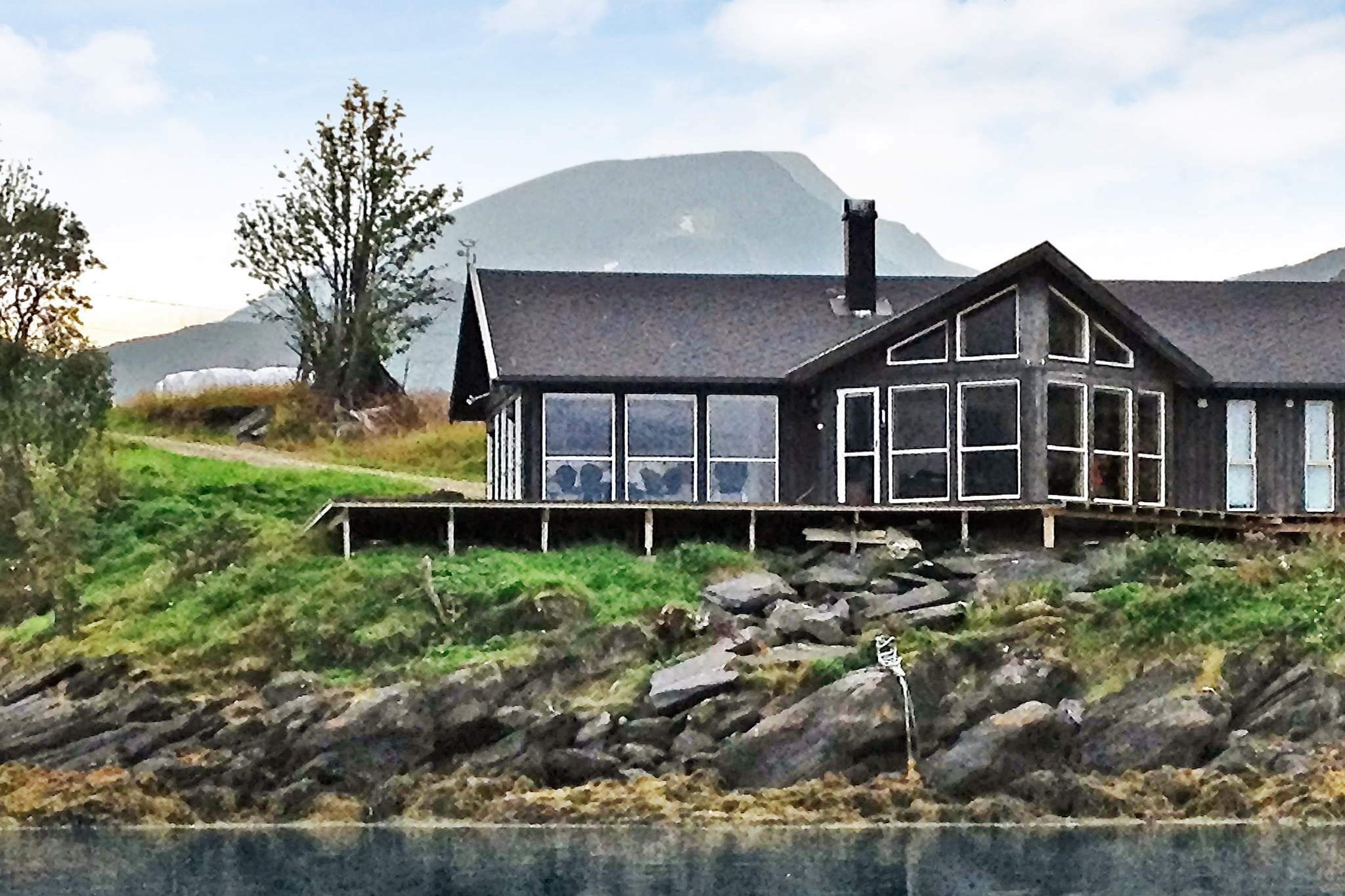 Great holiday cottage with outdoor whirlpool on Hinnøya, Norway's largest island. The cottage is situated by itself by the fjord, next to the village Flesnes, with large panoramic windows facing the sea and the nature. Here you can really enjoy the scenery with little streams running down the mountain sides. On the large terrace, start the day with your morning coffee, while watching the sun rise in the east with the sound of waves in the background. Enjoy the warm water of the whirlpool and admire the wonderful fjord view, winter or summer. This is also a great place if you want to experience winter with short, dark days and Northern Lights moving across the sky. After long, cold days outside, warm yourself in front of the wood-burning stove with glass windows in the living room. The cottage is tastefully furnished and comfortable with heated floors all year around. You have a yard behind the cottage that you can use all year around. The fjord has plenty of great fishing locations and a 14 ft self draining boat with control panel and 25 hp motor is available for rent between May 15th and September 15th. The boat is tied up to a floating dock 400 meters from the house. By the house, you have a basic canoe for 2 people at 50 NOK per day. The mountains around the fjord are great for hiking with several walking trails. They also have several fish rich lakes, and a salmon river runs at the end of the fjord for those with a fishing license. The cottage is a good starting point for day excursions by car to Lofoten and Vesterålen, with its impressive scenery and many small fishing villages that are worth visiting. The house has a high chair. The mezzanine has its own TV set up for PlayStation.
