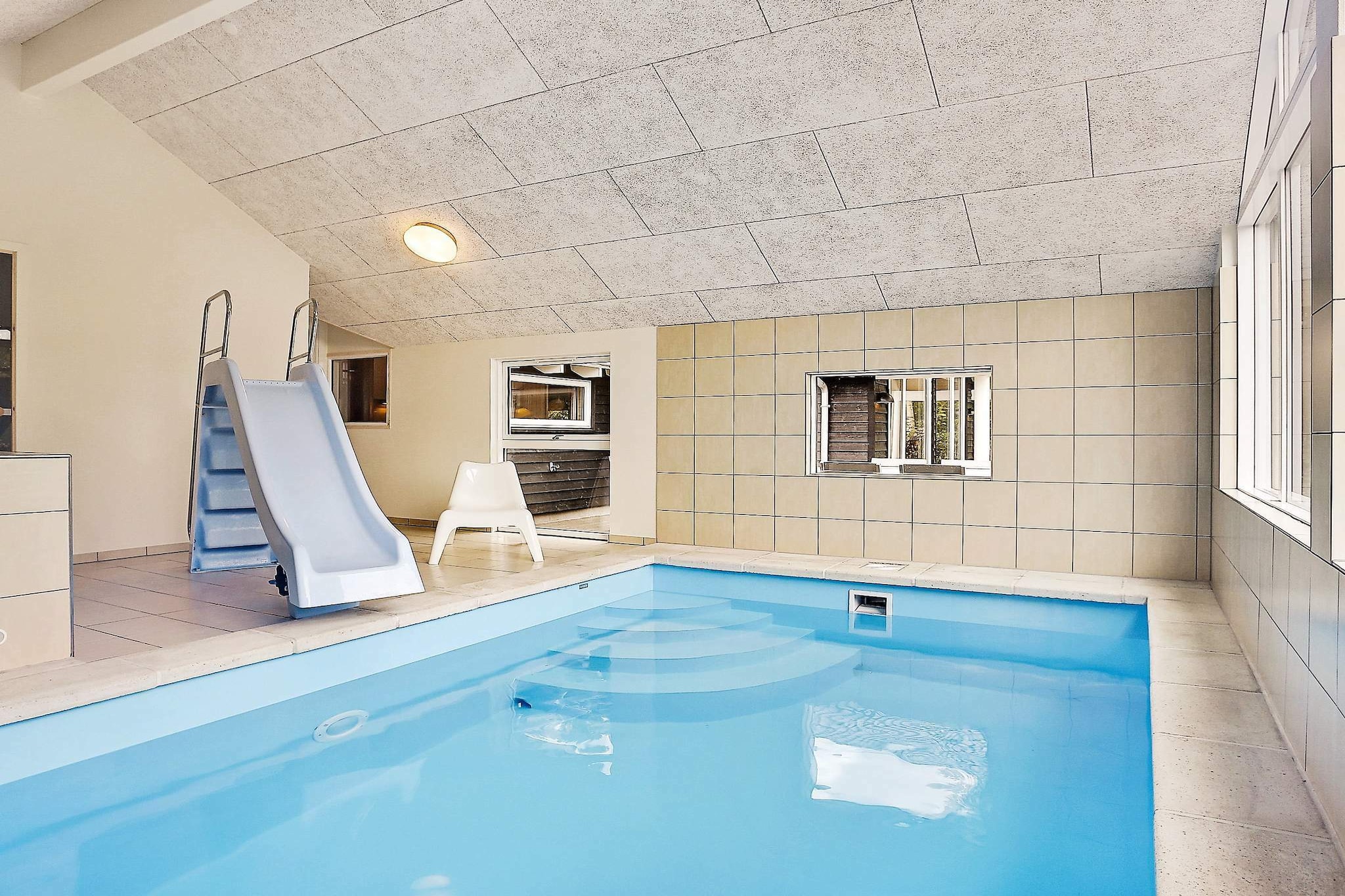 Holiday cottage located on a secluded plot close to one of the best beaches in Denmark. There is an 18 m² large swimming pool with slide for the children. Also a counter-current system which means you can improve your health with daily strokes all week combined with relaxation in the whirlpool and sauna which you will also find in the pool room. The activity room has billiards, electronic darts and table tennis. The living room has modern furnishings and a wood-burning stove for the cold evenings. There are more TVs in the house. In the kitchen you will find a large fridge, freezer and dish washer. At the long dining table the entire family can play games and eat dinners. The large terrace is perfect for relaxation while the children play in the garden. A part of the terrace is covered so you can have barbecues regardless of the weather. No letting to youth groups.