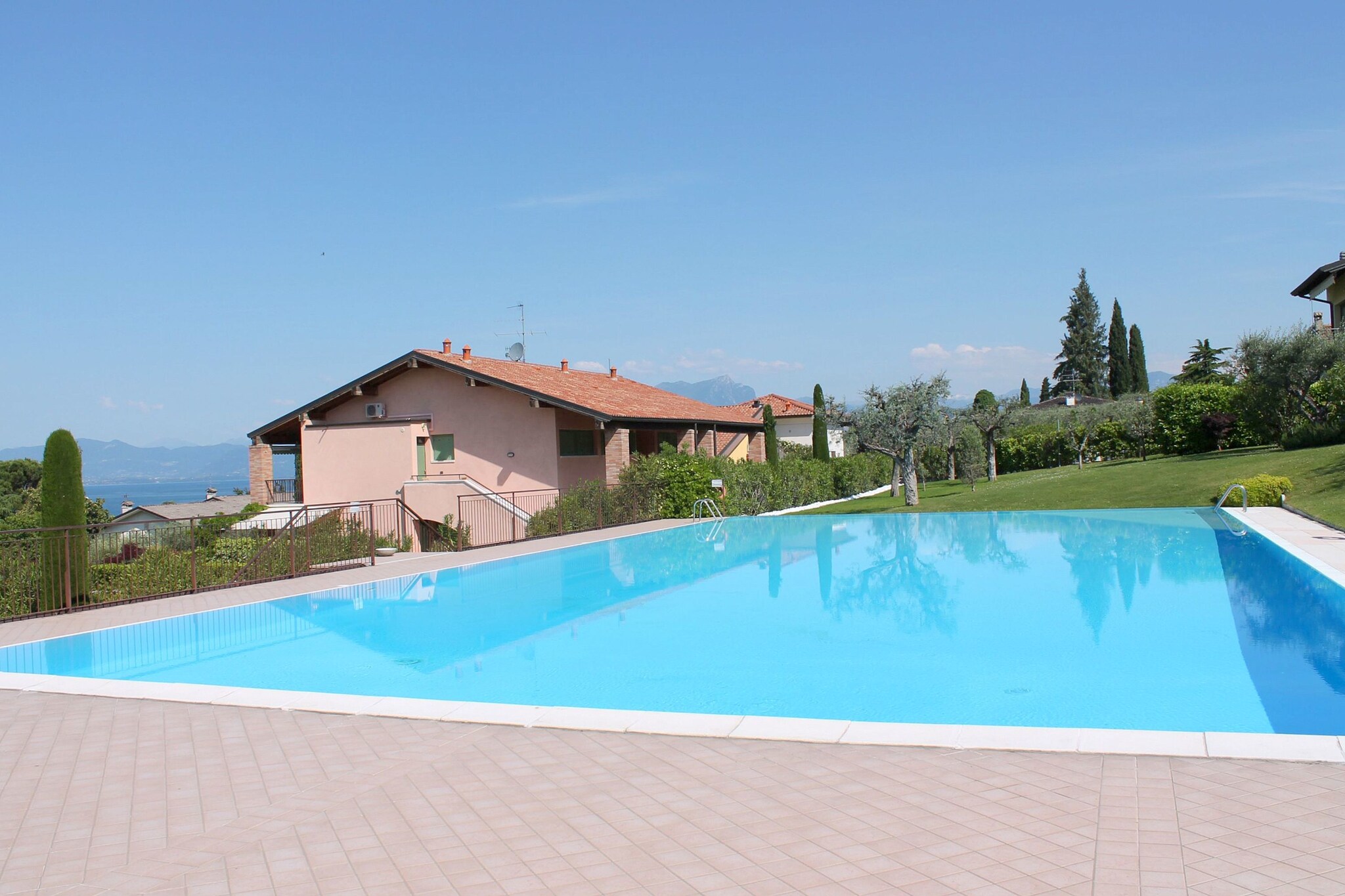 A beautiful holiday home with 3 bedrooms and a swimming pool, resting in an extremely quiet position in Lazise, invites you to spend a holiday in the Italian Lakes region. You can stay here in comfort with a family or group of 6 persons.



Lazise is a popular tourist destination owing to its natural beauty, numerous restaurants and stores, different sports offers, and proximity to Gardaland and Caneva Aquapark. The holiday home is at a short distance from the Cavazocca lakeside promenade of Lazise. Walking for just 0.4 km, you will arrive at the lake. A quiet street leads down to the town center at 2 km. 



This accommodation has central heating. On the terrace, you can enjoy the lavish preparations you make in the well-equipped kitchen. There is a private garage available. The swimming pool has a beautiful view of the lake and is one of the biggest and most beautiful of Lazise. In the private garden with garden furniture, you can relax and linger in the fresh air.