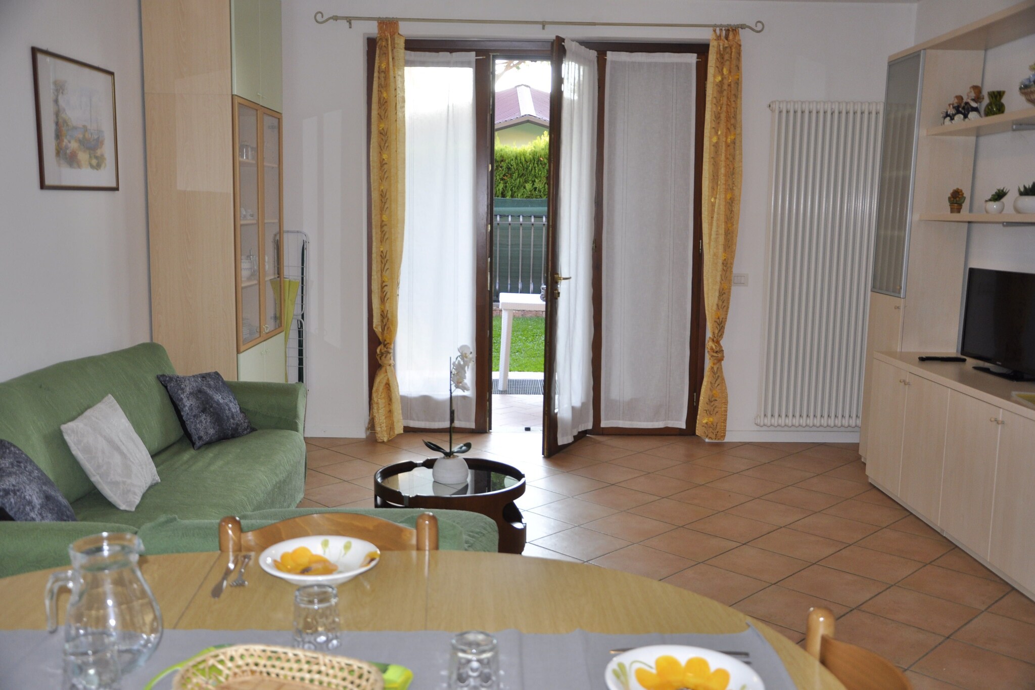 With a corner terrace and 4 bedrooms, this is a holiday home in a quiet but favorable position in Lazise, a town on Lake Garda. For your comfort, a garage and a shared swimming pool have been provided. The holiday home is excellent for a family or group having up to 7 guests.
Lazise is picturesque even by Lake GardaÂ’s high standards. The holiday home rests near the lakeshore promenade, at easy walking distance of 1 km from the town center of Lazise. You can explore the beautiful surroundings on foot or bicycles. Don't forget to boat here. If you are a winter sports enthusiast, Dolomiti Superski, with more than 2000 skiing slopes is nearby. 
This holiday home has central heating. The partially fenced, shared garden is perfect for children to play for long hours. After returning from excursions, you can sit and relax on the terrace, equipped with garden furniture. In the evenings, you can gather on the lovely barbecue corner on the grounds and enjoy smoked meals with some wine.