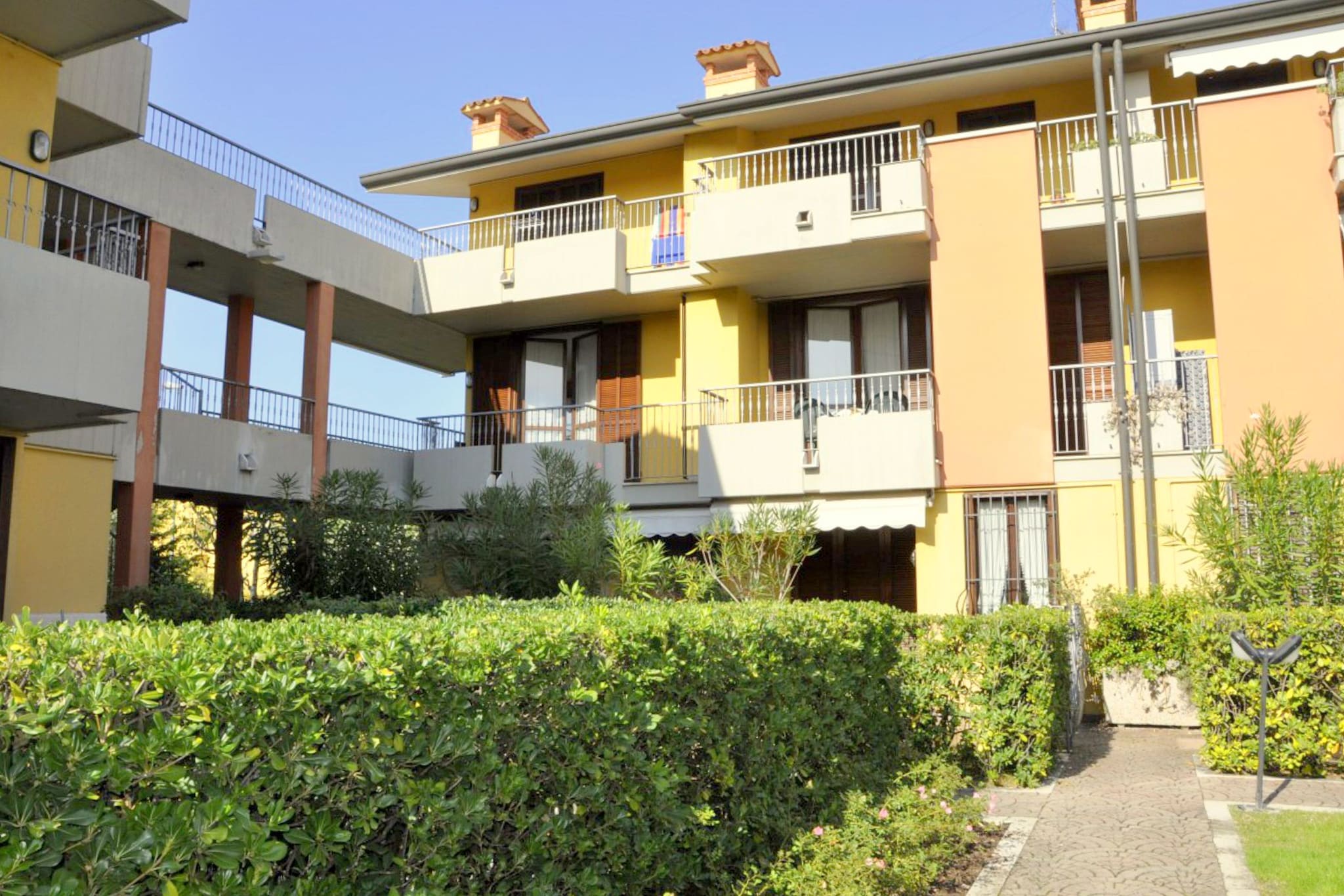 With elegant and simple furnishings, this 2-bedroom holiday home is located in Sirmione. It comes with a shared swimming pool where you can rinse all your stress. The stay is ideal for 6 persons, be it a family or group of friends.
The Thermal Baths of Sirmione are known worldwide and attract people from far and near. Your holiday home is in a very quiet but central position at 0.6 km the lake and lakeside outlets. It is 1.7 km away from the town center of Lazise, which is great to enjoy the streetscape and local life. The Madonna di Campiglio ski area, with skiing slopes of 150 km and cross-country slopes of 27 km is also nearby. You can enjoy skiing in the winter season here.
This accommodation has a spacious living/dining room and an open kitchen. Central heating ensures comfort when it is cold outside. There are 2 balconies to linger with a hot coffee mug or a refreshing cool drink. You can read or chit-chat with others on the shared terrace. A carport is available.