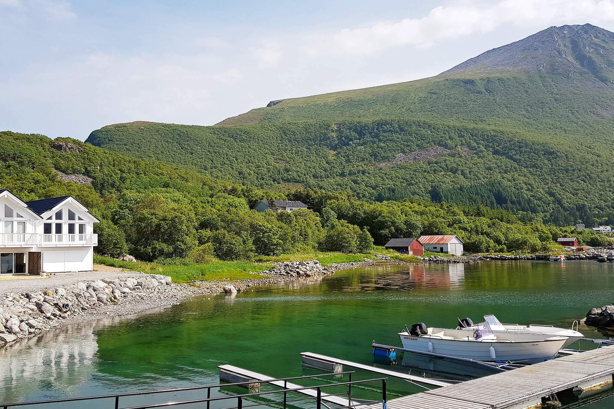 A modern holiday home in a traditional fisherman style with a great view and close to great fishing. The house is one of four units next to each other from 2017. The house is painted in bright and charming colours. There is a 30 m² large living room and kitchen on ground floor where you have a panoramic view of the fjord. All bedrooms and the bed loft has frame beds that you can combine into double beds. In the basement there is a living room with a rough maritime style with a kitchenette and long table, as well as room for storing fishing equipment and clothes. There is a 300 litre freezer. There are several terraces. High speed Wifi. Satellite dish with international channels. The closest town is Brattvåg, 10 km by car or 1-2 minutes across the fjord with boat. Ålesund is 50 minutes away. Go mountain hiking right behind the house. Go swimming on the beach 300 metres away. Park by the house or on the breakwater 50 metres from the house. 12 km to a fishing lake and 50 km to a river with salmon and trout. There is a private harbour 40 metres from the cottage with room for the boats available for rent. For rent: 1 x 21 ft Øien 620F with 60 hp Suzuki 4-stroke motor with GPS/sonar and chartplotter and 6 rodholders. 1 x 21 ft Øien 620F with Yamaha F80LB (80 HP), windscreen both on starboard and port side, Øien targa bar w/lantern, Garmin Echomap UHD 72CV w/GT2, 6 rod holders. Great fishing conditions in the fjord. A 16 ft rowing boat is also for rent. Life jackets are included in the boat rent.