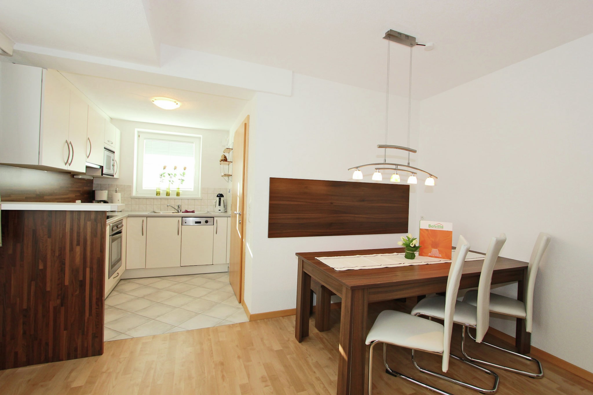 Ground floor: (open kitchen(cooker(ceramic), coffee machine, microwave, dishwasher), Living/bed room(single sofa bed, TV(flatscreen, satellite), dining table, stereo unit), bedroom(double bed), bedroom(double bed), bathroom(bathtub with shower, shower(unit), washbasin, toilet, hairdryer))\n\nEntrance, cot, heating(central), terrace, parking