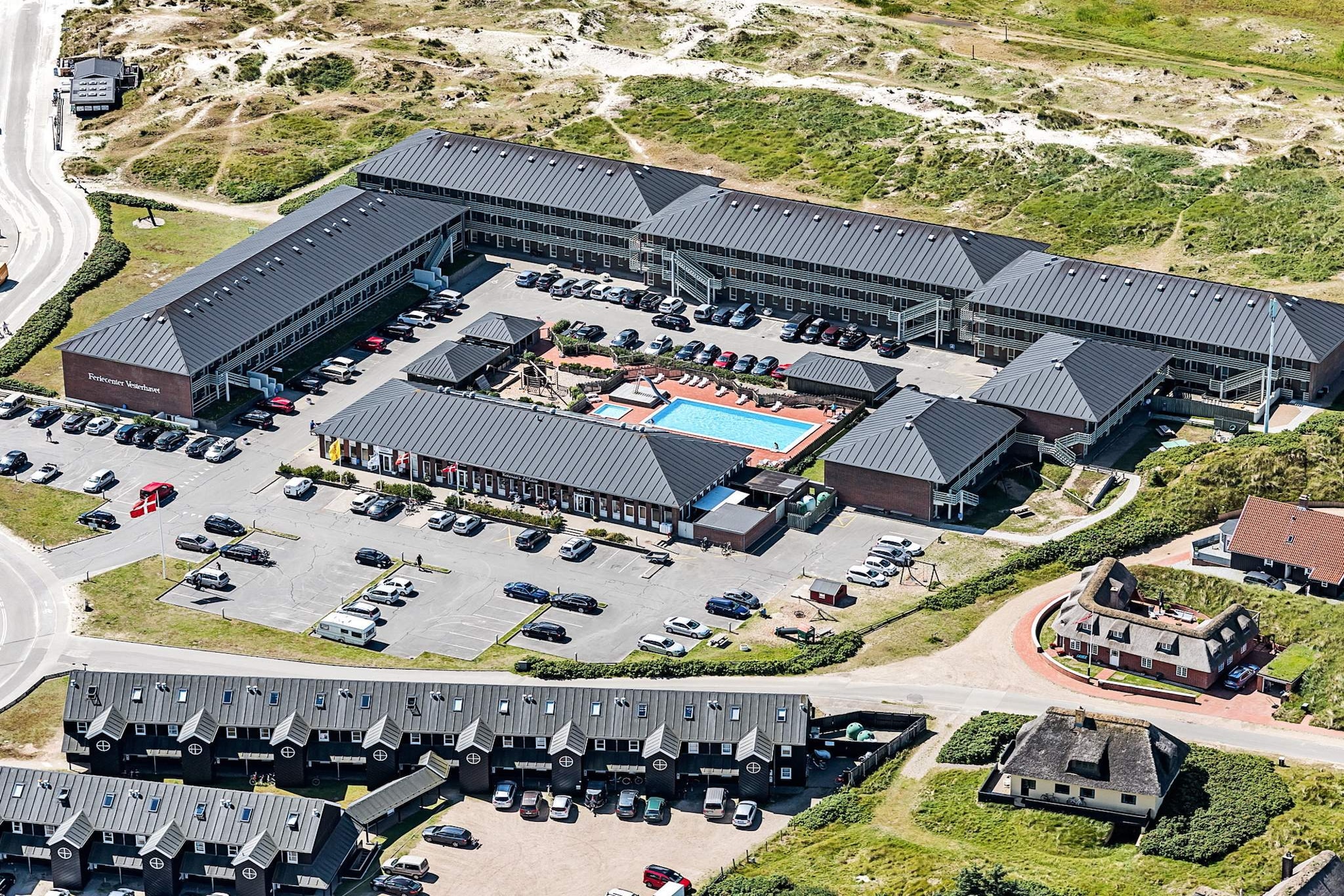 This charming hotel, located in the picturesque Fanø, South West Jutland, Denmark, offers a peaceful retreat for those seeking a relaxing holiday. Situated near the coast, the hotel provides a cozy, welcoming atmosphere with modern amenities and a beautiful setting. Guests can enjoy a variety of outdoor activities, including walks along the beach and nearby nature reserves, all while staying in a well-maintained property that combines comfort with scenic views. The hotel is ideally located for those looking to explore the surrounding area. Attractions such as Legoland, Givskud Zoo, and the Tirpitz Museum are within reach, providing fun and cultural experiences for visitors of all ages. Additionally, the nearby Universe Science Park and Esbjerg Museum offer unique opportunities to enjoy both nature and history, making it an ideal destination for families and adventure seekers alike. The hotel offers three types of rooms to cater to different needs and preferences. The Premium Suite is perfect for couples, featuring a cozy living room with a fireplace, a double bed, and a shared kitchen and bathroom. The Double Room offers a more intimate setting, with a double bed and TV, along with access to a shared kitchen and bathroom. Finally, the Suite provides a comfortable space with a living room and a double bed, as well as shared kitchen and bathroom facilities. All rooms include outdoor seating areas with garden furniture and terraces, offering guests a relaxing space to unwind after a day of exploration.