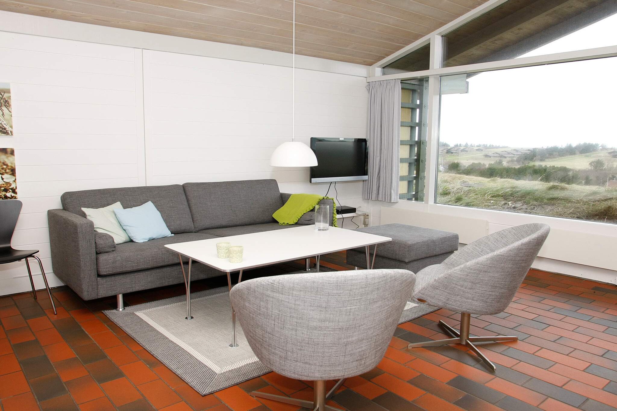 Enjoy your holiday in this cozy 61 m² holiday home for 4+2 people, located in the scenic Vigsø Holiday Park in North West Jutland. The house offers a bright 20 m² living room with cable TV and radio, perfect for relaxing after a day of exploring. There are two bedrooms one with a double bed, the other with two single beds—as well as a loft (hems) with two additional sleeping spaces. The kitchen is fully equipped with an electric stove, fridge with freezer compartment, cooker hood, dishwasher, and coffee machine.

The modern bathroom features a shower, toilet, sink, and underfloor heating ideal for comfort during all seasons. Situated close to the child-friendly beach in Vigsø Bay, the home offers a perfect balance between tranquility and easy access to fun and adventure. Guests enjoy free access to the indoor swimming pool with a 50-meter water slide, whirlpool, and heated pools. Other on-site activities include mini golf, tennis, motocross, and bike rentals, ensuring fun for the entire family.

Vigsø Holiday Park consists of 175 individual homes spread across three village-style areas (A, B, and C). All homes include free high-speed internet and a variety of TV channels. Final cleaning is included, and flexible bookings are available year-round with a minimum of two nights. Pet-friendly options are available (registration required, fee applies). Whether you're after a peaceful escape or an active holiday, this home provides a great base in the heart of nature.

Note: Please call the Danland team to confirm whether pets are welcome here or not.