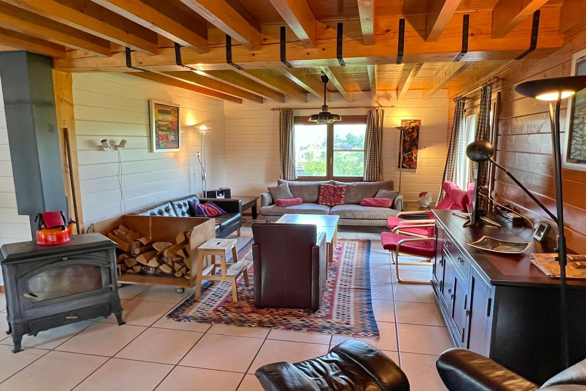 Very spacious (walled) wooden chalet for 10 people on the edge of the village of Hampteau. Large garden with a view over the Ourthe valley. Wheelchair accessible. Ideal for a 3-generation stay. Walled chalet for 10 people, located on the edge of Hampteau, with a beautiful view over the Ourthe valley. Ground floor: spacious L-shaped living room (wood stove, SMART TV, DVD) and dining area with open kitchen (4 electric hotplates, combi microwave with grill and oven function, oven, dishwasher, fridge-freezer), 1 bedroom (with high-low bed and 1 pers. bed). Bathroom usable for wheelchair users, washing machine. Hoist and shower stretcher available. Separate toilet (wheelchair toilet). Floor: 3 large bedrooms, bathroom with bath and shower. Separate toilet. Electr. heating. Very large garden (16 acres) with garden furniture, barbecue and volleyball net. Terrace on the south. Garage with table tennis. Beds: 6 x 1 pers. + 2 x 2 pers. + high chair. Stag parties and youth groups are not allowed. PETS NOT ALLOWED. FREE WIFI.