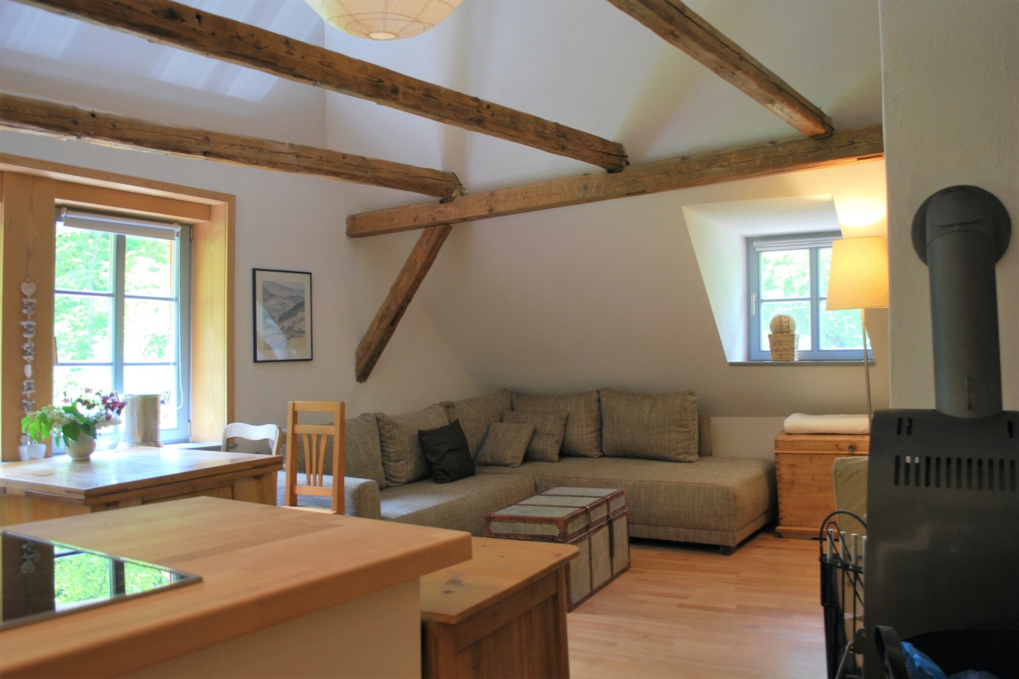 Charming Watermill Retreat
Step into this quaint 2-bedroom apartment set on the upper floor of a historic watermill in Thuringia. Accommodating up to 4 guests, it’s ideal for small families or friends seeking a relaxing stay. The apartment opens to a bright living area with a wood stove and floor heating, fully equipped kitchen, and a large dining table for shared meals. Bedrooms are cozy and well-furnished, and a modern bathroom completes the space. Step outside to enjoy the shared garden with barbecue and a private sauna for two (extra charge), or simply relax on the deckchairs with a book.
Active Thuringia Location
Nature and outdoor enthusiasts will love the extensive sports and leisure opportunities nearby. Hiking and cycling trails are less than 1 km away, and the region offers open-air pools, carriage rides, and water sports 15 km from the apartment. Golfers can enjoy a 20 km drive to the local course. Supermarkets and restaurants are only 3 km away, making it easy to explore local cuisine while experiencing the scenic charm of Thuringia.
Comfort and Convenience
Guests can access the apartment via a shared outside stairway, with parking and bicycle storage available. Children will enjoy the play equipment, while adults can relax in the sauna or garden. The apartment blends historic charm with modern comforts, offering a warm, welcoming retreat for those looking to unwind, reconnect with nature, and explore the surrounding Thuringian Forest.