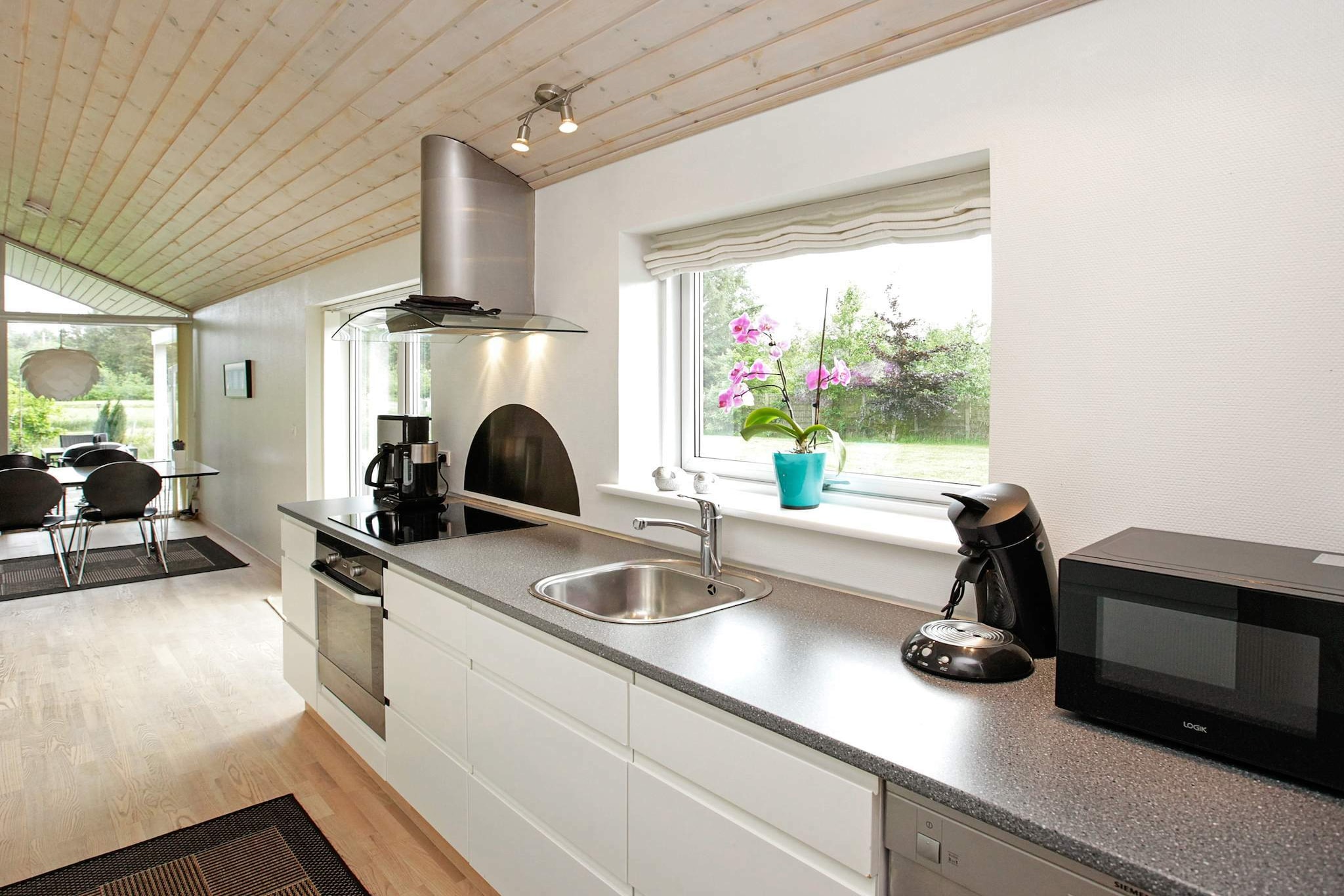 open kitchen(cooker(electric), hood, coffee machine, microwave, dishwasher, fridge(+ freezer), freezer(60-99L), tumble dryer, washing machine), Living/bed room(TV(cable, german television channels, danish TV channels (DR1 and TV2)), DVD player, radio, CD player, stereo unit, high chair), bedroom(double bed), bedroom(double bed), bedroom(2x single bed, children\'s bed), bathroom(floor heating)(bathtub or shower, washbasin, toilet), bathroom(floor heating)(bathtub or shower, washbasin, toilet), Bubble bath(indoor, heated, 2 persons), sauna(indoor, heated, 3 persons), heating(electric), terrace, BBQ, air to air heatpump
