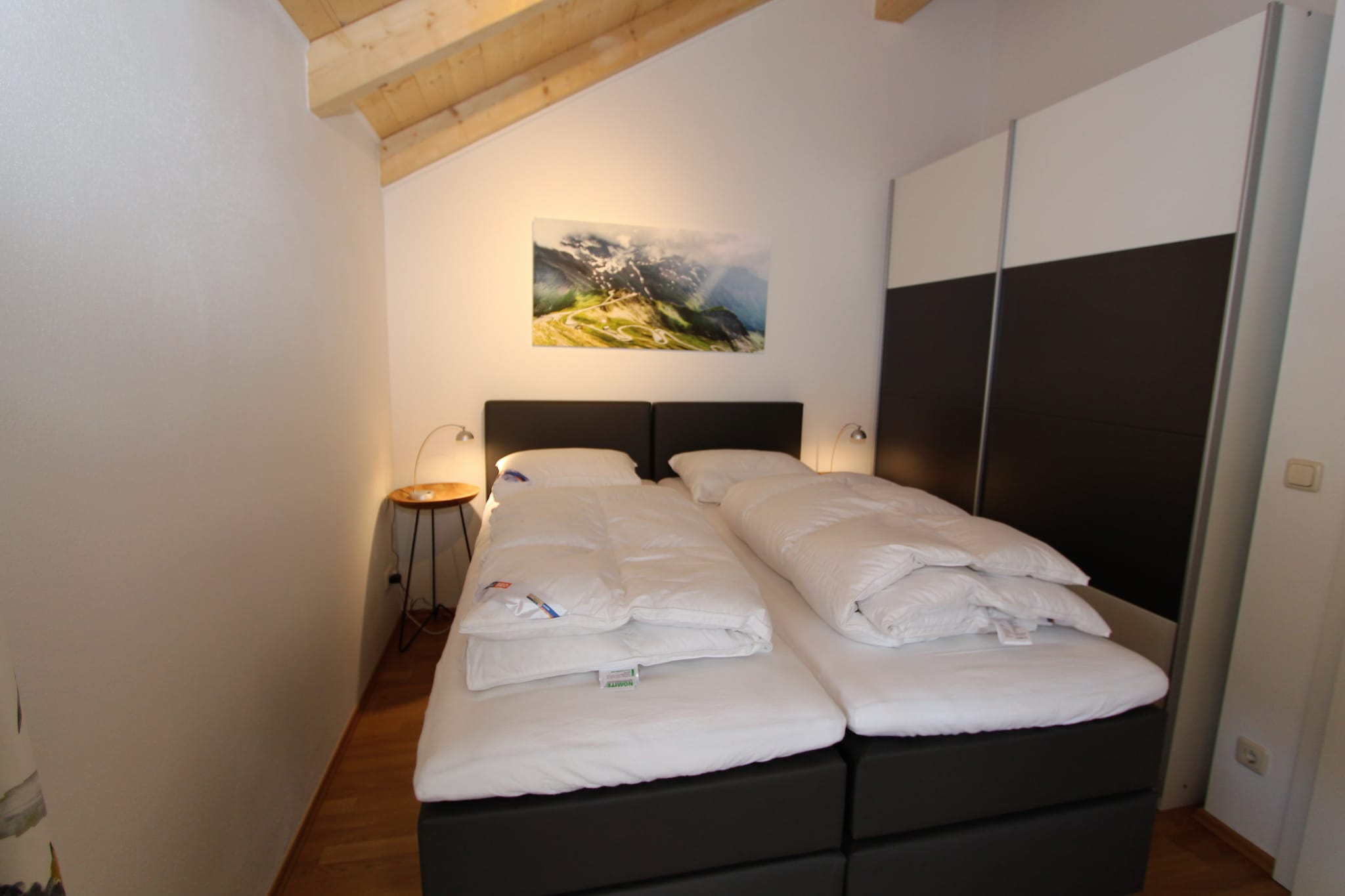 Ground floor: (hallway, Living room(TV(flatscreen), dining table, stove(wood), seating area, DVD player, stereo unit), open kitchen(cooker(4 ring stoves, ceramic), coffee machine, oven, microwave, dishwasher, fridge), sanitary facility(washbasin, toilet, washing machine))\n\nOn the 1st floor: (bedroom(bunk bed), bedroom(2x single bed), bathroom(shower, washbasin, toilet), bathroom(shower, washbasin, toilet))\n\nOn the 2nd floor: (mezzanine(2x single bed))\n\nstorage, carport, garden doors, terrace, garden, garden furniture, BBQ(electric), parking, children\'s bed, high chair