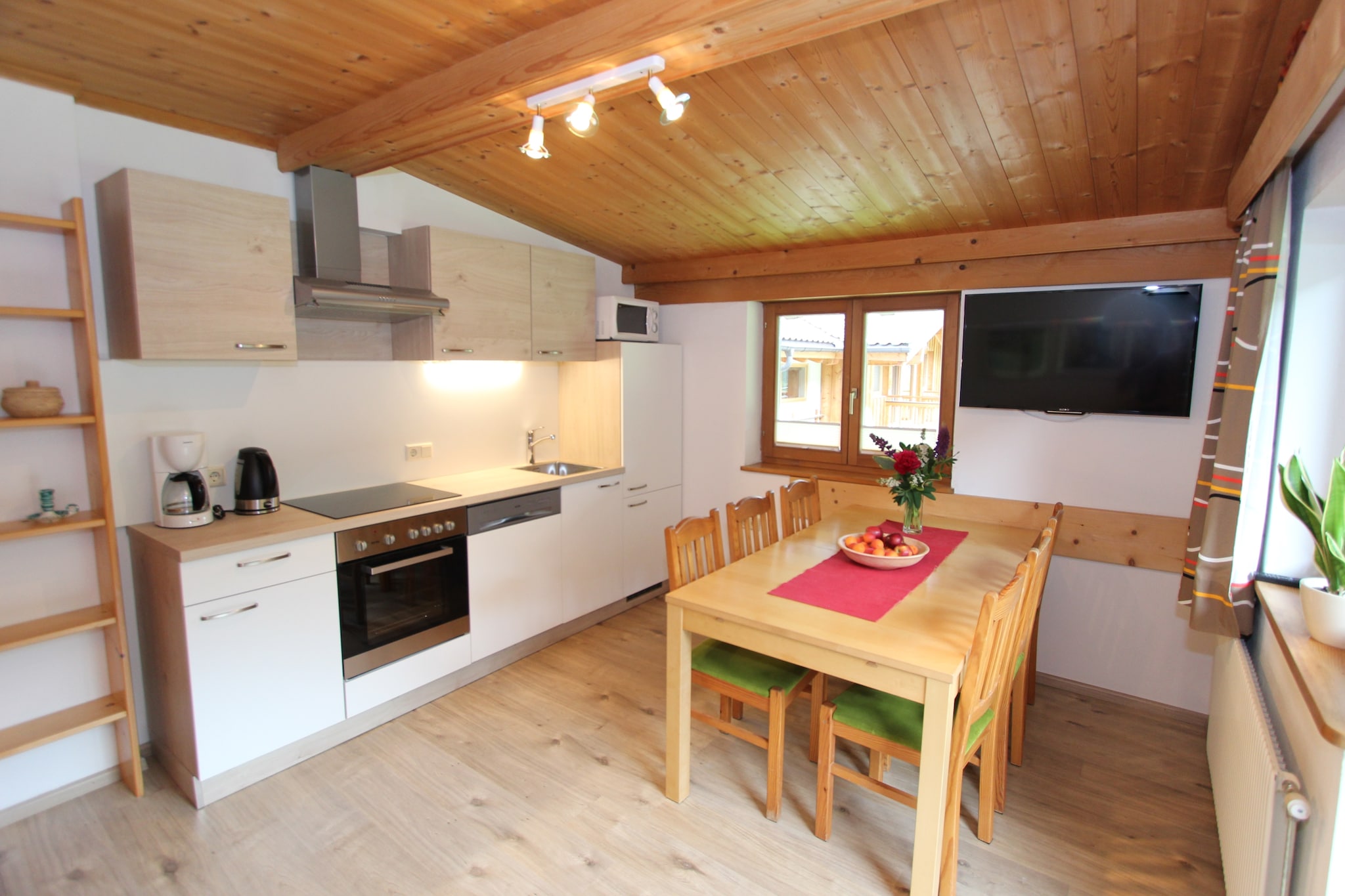 On the 1st floor: (Living room(double sofa bed, TV, balcony), open kitchen(cooker(4 ring stoves), oven, microwave, fridge-freezer), bedroom(double bed, double sofa bed, TV, balcony), bedroom(double bed), bedroom(double bed), bathroom(bath tub, shower, washbasin), toilet)\n\nski storage(ski boot heaters), heating(central), parking, children\'s bed, high chair