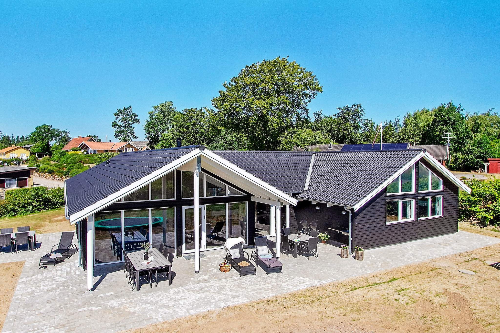 Well-appointed cottage with swimming pool, whirlpool and sauna as well as various activities located by Hvidbjerg Strand. The house's pool section contains both a large swimming pool with swimming coach, large, built-in whirlpool and sauna with room for 4 people. The swimming pool is 18 m & # 178; and with slide for the kids. Here, young and old will surely spend a lot of hours playing and splashing. In the activity room, table tennis, billiards and electronic darts can be played. There are several TVs in different departments as well as PlayStation4 and Nintendo Wii for entertainment. The dining / living area is tastefully decorated with stereo with CD player, TV, blu-ray player, high chair, sofa area and wood burning stove. In the well-thought-out kitchen, there is a large refrigerator, freezer and two dishwashers and two stoves, so there is plenty of opportunity for cooking. The house is extremely spacious and well-dimensioned and built around two sleeping areas with a total of six bedrooms. Each section has its own bathroom and there is an additional bathroom in connection with the pool section. In addition, there is a loft with four extra beds, which the children are guaranteed to use as a playground. On the plot there is a swing, sandpit and trampoline (used at your own risk / insurance). On the west-facing terrace you can enjoy the sun all day Due to the size of the house, the price of cleaning at this Skanluxhus differs from the normal list price. Settlement of consumption, cleaning and deposit is paid in cash on site to the caretaker. Not for rent to youth groups.
