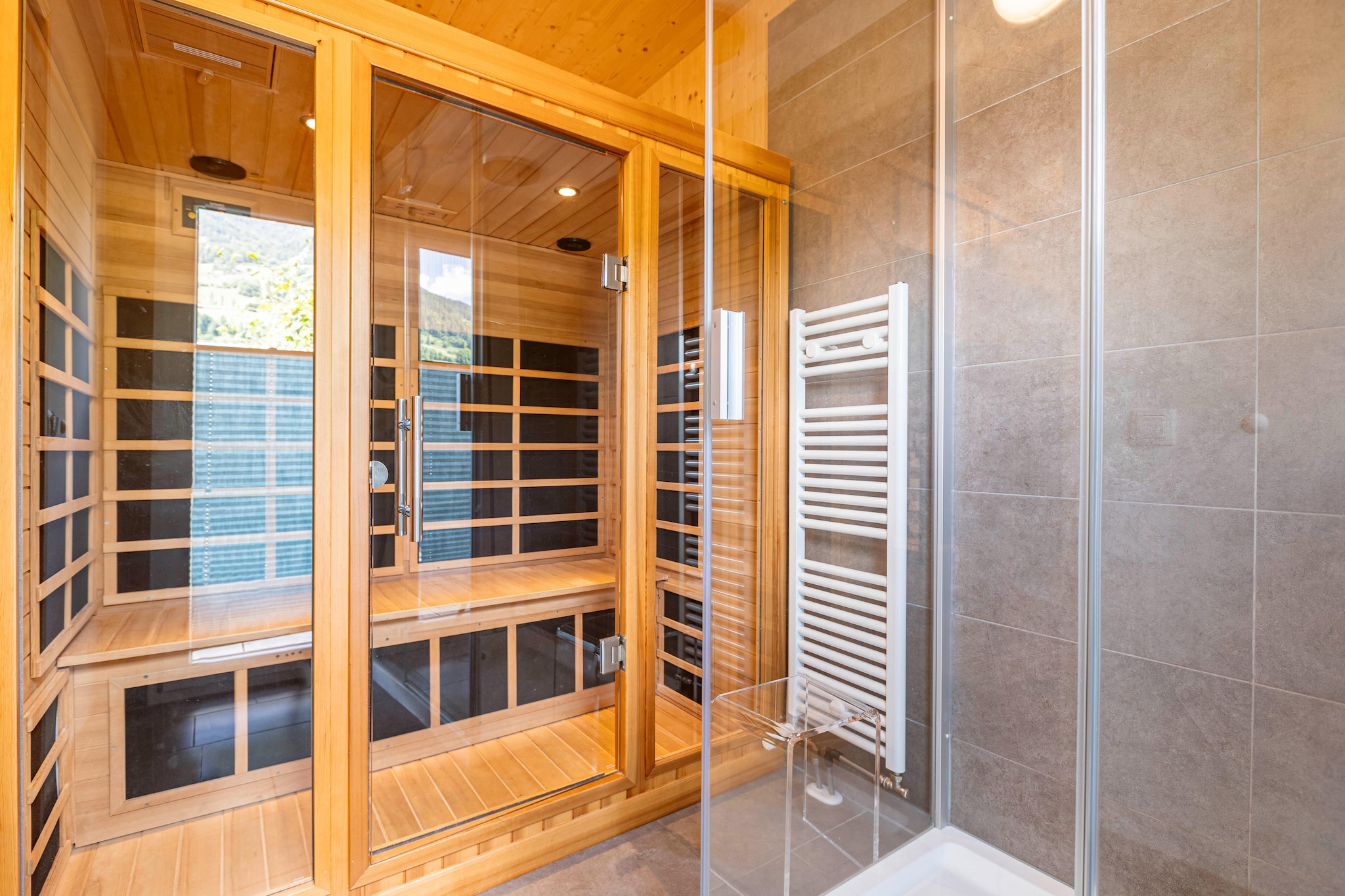 Ground floor: (Living room(TV(satellite), DVD player, gas fireplace), open kitchen(electric kettle, toaster, cooker(ceramic), coffee machine(espresso, filter), oven, microwave, dishwasher, fridge-freezer, dishes and cutlery(Bowls, chopsticks, plates, cups, etc.)), bathroom(shower, infrared sauna, washbasin, hairdryer), toilet, Internet access)\n\nOn the 1st floor: (bedroom(double bed), bedroom(double bed), bedroom(double bed), bedroom(2x single bed), bathroom(Bubble bath, shower, washbasin, toilet))\n\nBubble bath, storage, grill, hot tub, washing machine, heating(electric, central), terrace, garden, garden furniture, parking, drying cabinet