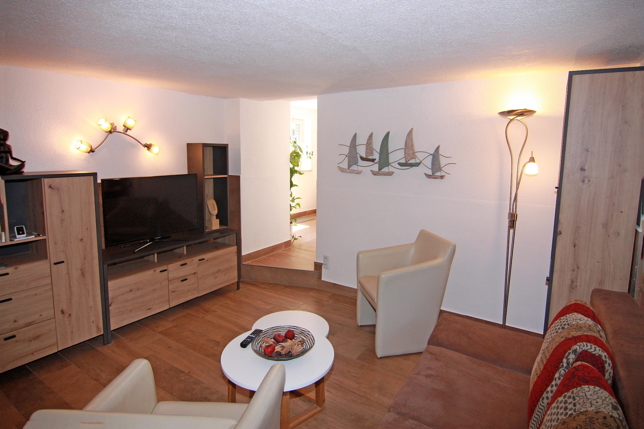 This charming basement-level holiday apartment in Boltenhagen offers a peaceful retreat just 300 meters from the Baltic Sea’s white sandy beach. With its own private entrance and garden terrace, it’s perfect for couples or solo travelers seeking comfort and convenience near the coast.
Inside, the apartment features a modern bedroom with ample storage and a cozy living area with a well-equipped kitchenette, ideal for preparing delicious meals. Guests can enjoy quiet mornings on the terrace or set out to explore the vibrant town center, spa park, pier, and promenade, all within walking distance. 
Extras include WiFi, a laundry package, parking, and all energy costs. Whether you're here to relax, explore, or simply breathe in the sea air, this apartment is a delightful base for your Baltic getaway.
Families will appreciate the nearby playgrounds and wide beach space, while cyclists can follow scenic trails through forests and fields toward Travemünde. The Weiße Wiek marina and old fishing port offer fresh seafood and waterfront charm. A day trip to the Hanseatic city of Wismar (20 km) reveals a beautifully preserved old town and cultural gems.