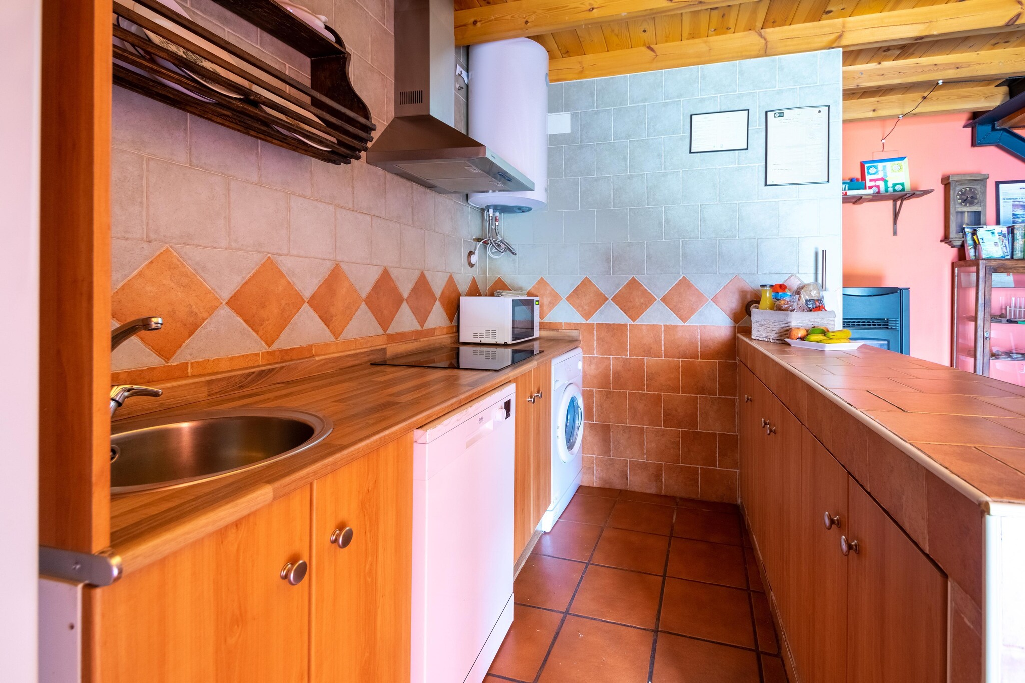 Ground floor: (Living room(TV, fireplace, seating area), Kitchen(toaster, cooker, coffee machine, oven, microwave, fridge-freezer, washing machine), bathroom(shower, washbasin, toilet), cot, patio, garden furniture, BBQ, play equipment, party games, toys)\n\nOn the 1st floor: (bedroom(double bed), bedroom(single bed, single bed), bathroom(Bubble bath, washbasin, toilet, hairdryer))