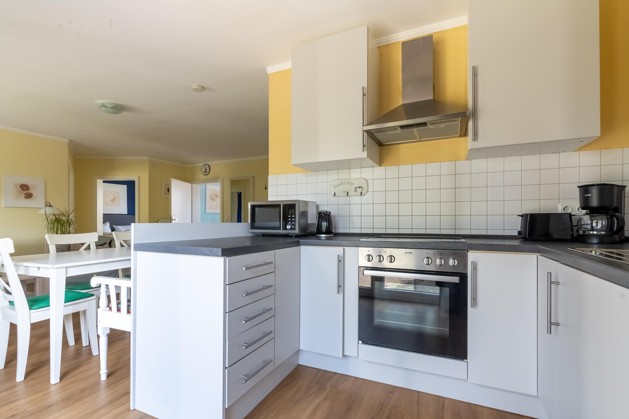 On the 1st floor: (open kitchen(electric kettle, cooker, coffee machine, oven, microwave, dishwasher, fridge), Living/diningroom(TV, dining table(6 persons), radio, balcony), bedroom(double king size bed, TV(flatscreen)), bedroom(double king size bed), bathroom(shower(walk-in shower), washbasin, toilet), bathroom(shower(walk-in shower), washbasin, toilet, hairdryer))\n\nAttic: (bedroom(double king size bed, TV), bedroom(double king size bed))\n\ncamping cot, washing machine, heating, terrace, garden, garden furniture, parking, high chair