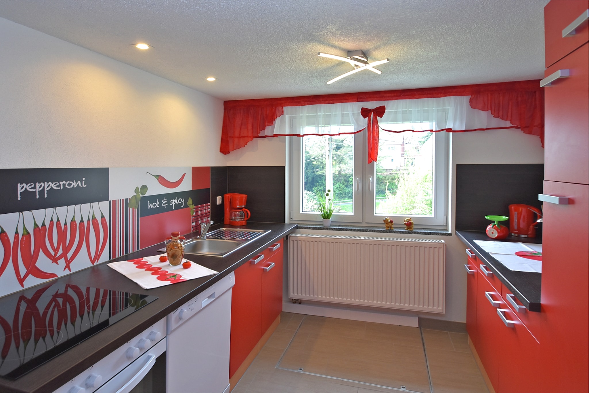 Ground floor: (open kitchen(toaster, cooker(4 ring stoves, ceramic, electric), coffee machine(filter), oven, waffle iron, combination microwave, dishwasher, fridge(+ freezer)), Living/diningroom(TV(flatscreen, satellite), dining table, radio), bedroom(double bed), bedroom(double bed(180 x 200 cm), bunk bed), bathroom(shower, washbasin, toilet), Landing)\n\ntumble dryer(paid), cot, washing machine, heating(central), garden(shared with other guests, 1000 m2), bicycle storage, garden furniture, BBQ(shared with other guests, on request, charcoal), parking, pond, parasol, play equipment, high chair