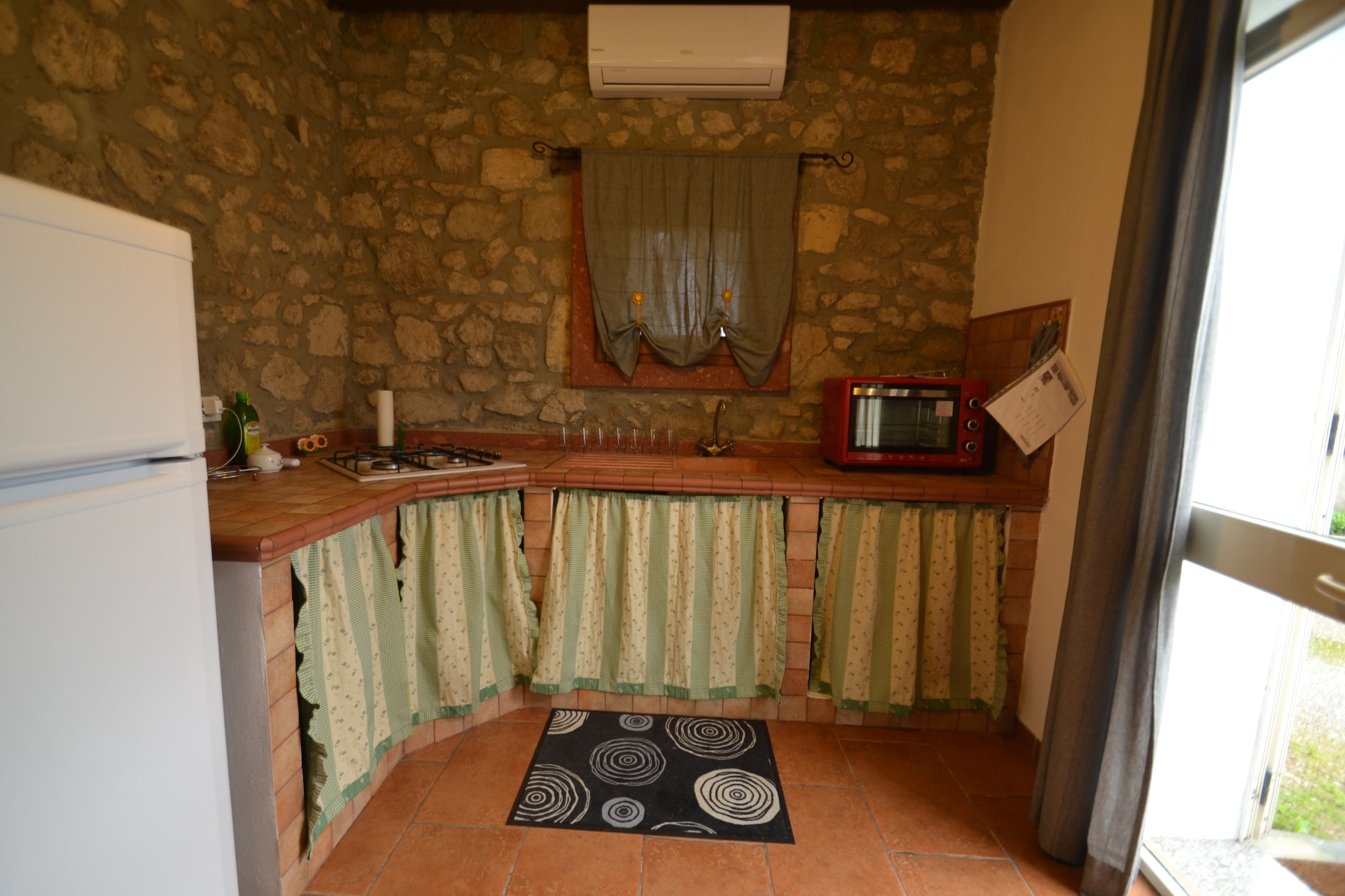 Situated in Calasetta near the lagoon and the sea, this serene cottage has a living-bedroom to accommodate 2 people. It offers a lovely garden and a shared barbecue to relax and is ideal for a small family or a couple to stay in.



Get ready to explore some fantastic places nearby. You can visit Acropolis underneath the Punic city, Saint Antioco martyr's catacombs, Saint Antioco's basilica, and the Roman Fountain. The Nativity grotto and the Giant's tomb are also a must-visit. Enjoy the evening sunset from the sea at 2 km. Lovely beaches facing both North and South gives a wonderful experience. The town center is 1 km and the supermarket and restaurants are 2 km.



The cottage is bright and ventilated with parking and paid to heat. The cozy living-bedroom with TV and the modern kitchen ensures a pleasant stay. There is a veranda and a furnished garden to enjoy the barbecue. You can refresh it from the outside shower.



Cagliari Airport lies 90 km away.