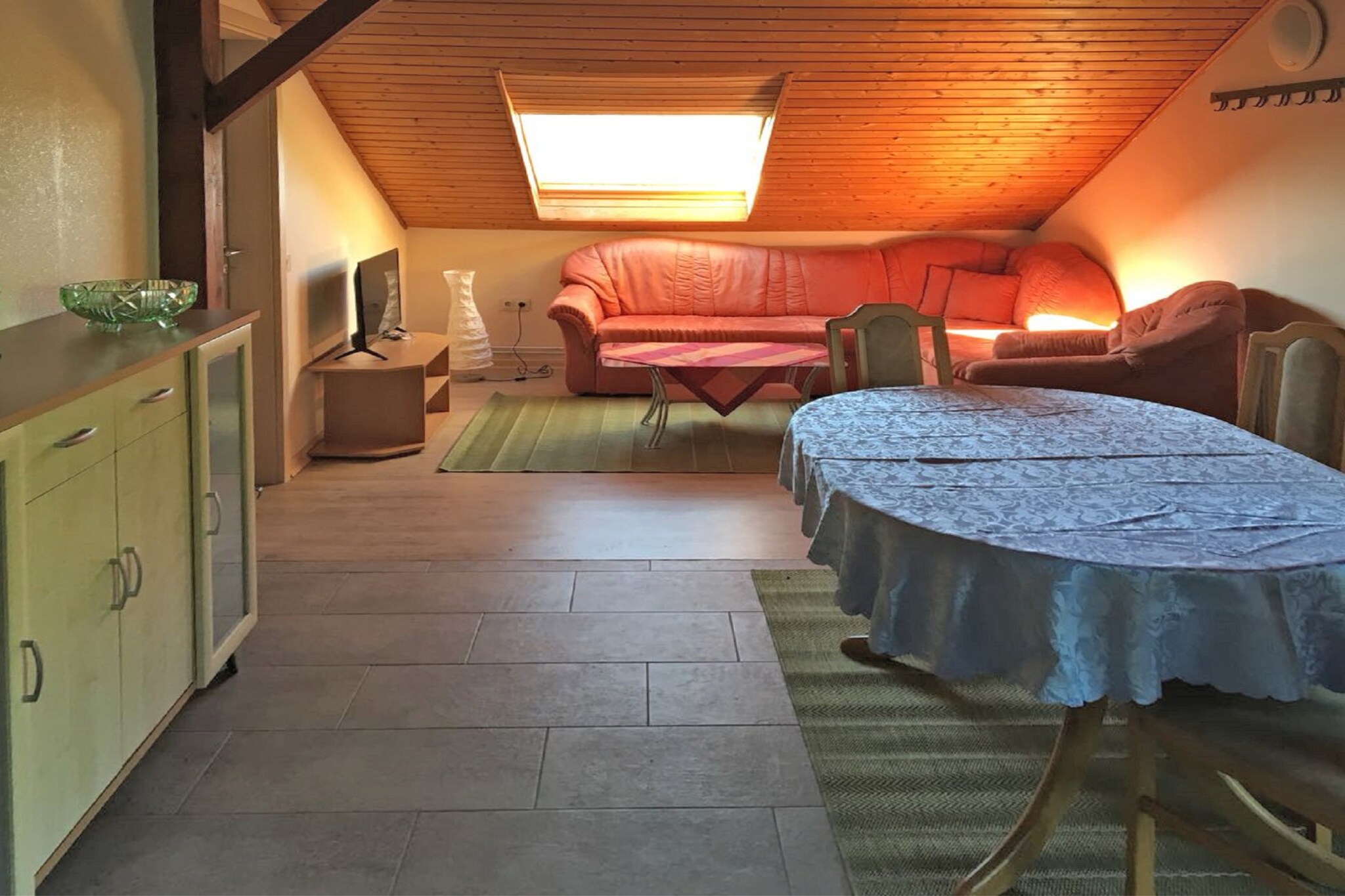 Attic: (Entrance, hall, open kitchen(toaster, cooker(4 ring stoves, electric), coffee machine(filter, pads), oven, waffle iron, dishwasher, fridge), Living/diningroom(TV(satellite), dining table), bedroom(accessible via interconnecting room)(single bed, single bed, single bed), walk-through bedroom(double bed), bathroom(shower, washbasin, toilet))\n\ncot, heating(central), terrace(private, 30 m2), garden furniture, BBQ(charcoal), parking, deckchairs, parasol, high chair
