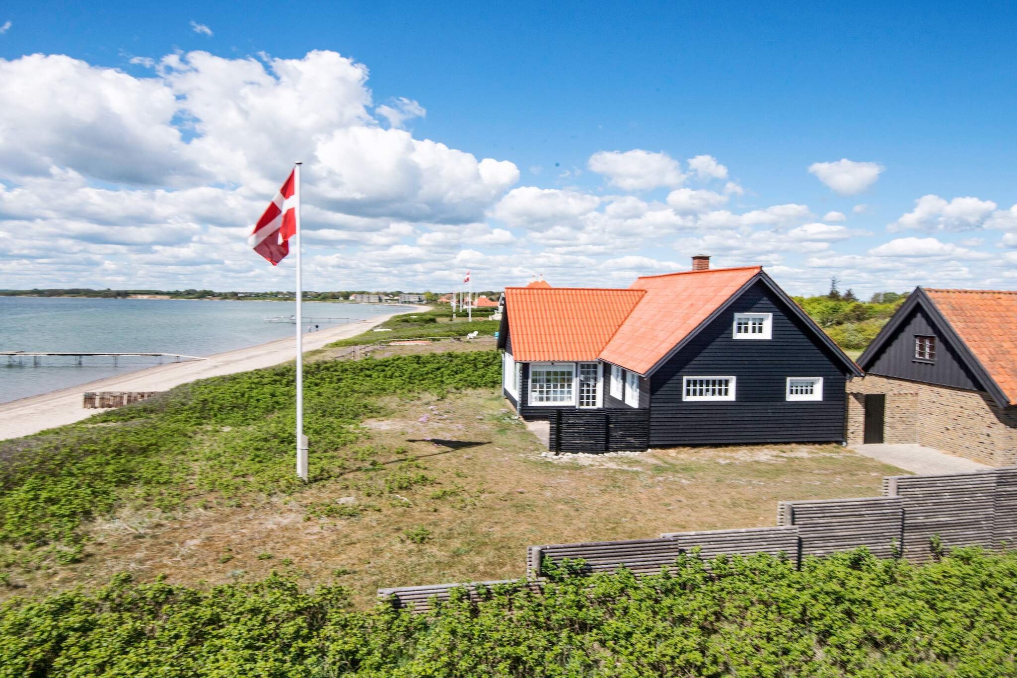Holiday home located right down to the sea and with its own beach at Juelsminde. You will rarely find this unique location anywhere else. The cottage was built in 1932 and renovated continuously without changing the atmosphere, so you experience the atmosphere from that time. The ground floor contains 2 living rooms as well as a kitchen, bathroom and hallway. The 1st floor of the house contains three bedrooms, which can accommodate 4 adults, the last available bed is 120x180cm. The house has a fantastic terrace next to the water and an enclosed solarium, where you can always find shelter. Not for rent to youth groups. Pets are not allowed.
A refundable deposit might be charged closer to your check-in date. This deposit covers utilities consumed during your stay and any additional services that may be taken. The final amount will be adjusted based on actual meter readings, actual usage of extra services, and any remaining balance will be refunded within 21 days after checkout.