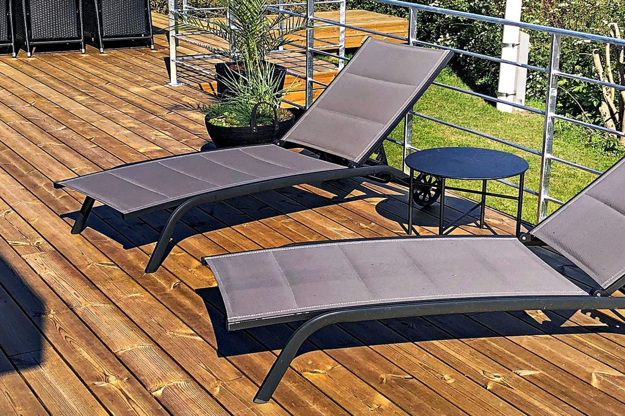 Annex: (2x single bed)\n\nInternet Access DSL, open kitchen(cooker(electric), hood, coffee machine, microwave, dishwasher, fridge-freezer, washing machine), Living/bed room(TV(cable, german television channels, danish TV channels (DR1 and TV2)), radio, high chair), bedroom(double bed, cot), bedroom(2x single bed), bathroom(bathtub or shower, washbasin, toilet), conservatory, carport, bath tub(outside), terrace, garden, BBQ, geothermal energy, air to air heatpump