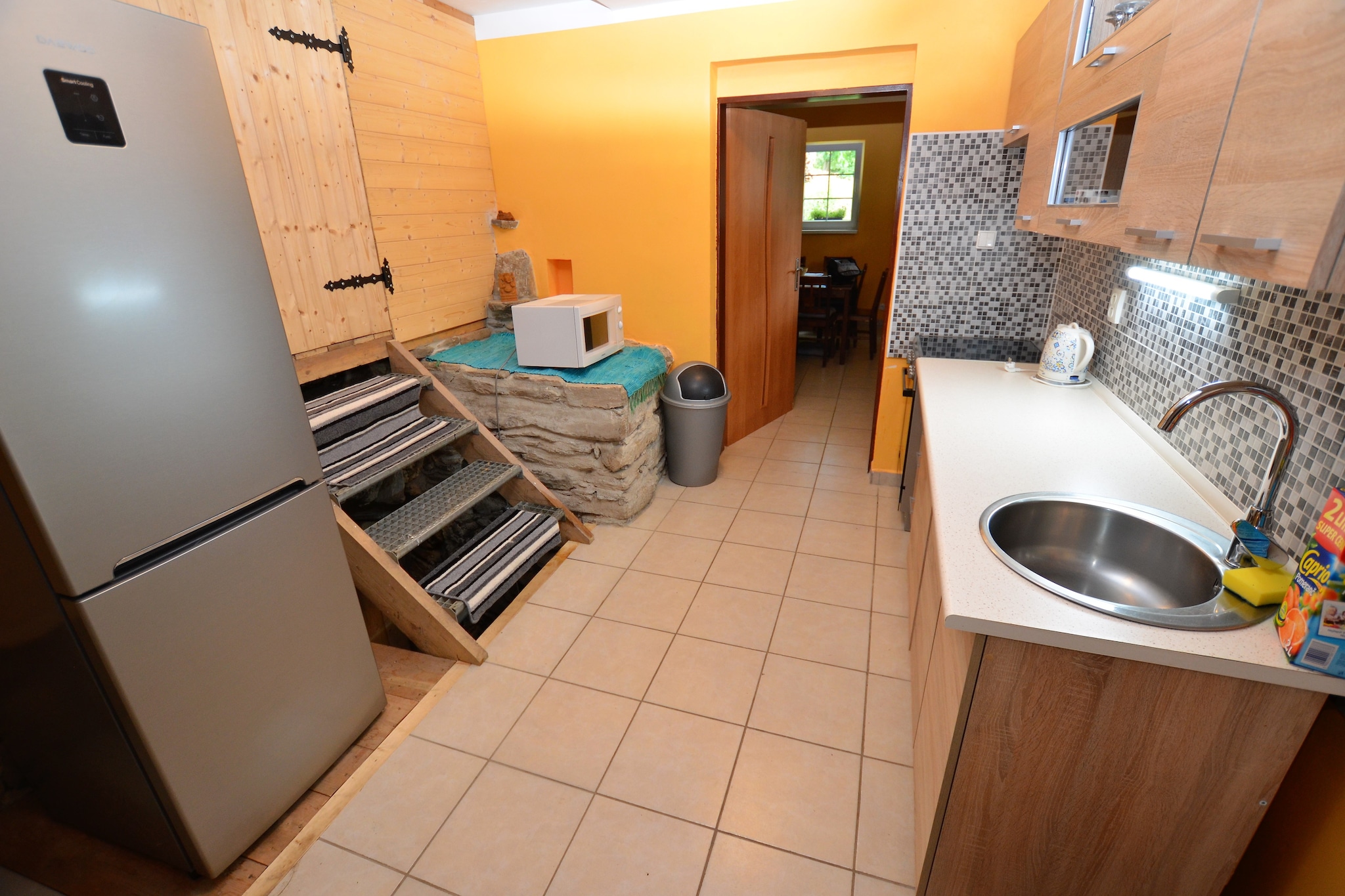 Ground floor: (Entrance, Living room(TV, dining table(8 persons), decorative fireplace, seating area), Kitchen(electric kettle, cooker(4 ring stoves, ceramic), oven, microwave, fridge-freezer), bathroom(shower, washbasin, toilet))\n\nOn the 1st floor: (bedroom(single bed, double bed), walk-through bedroom(4x single bed(90 x 200 cm)))\n\nAttic: (Gallery bedroom(4x single bed(90 x 200 cm)))\n\nterrace(private, roofed, 8 m2), garden(private), garden furniture, BBQ, swimming pool(private)