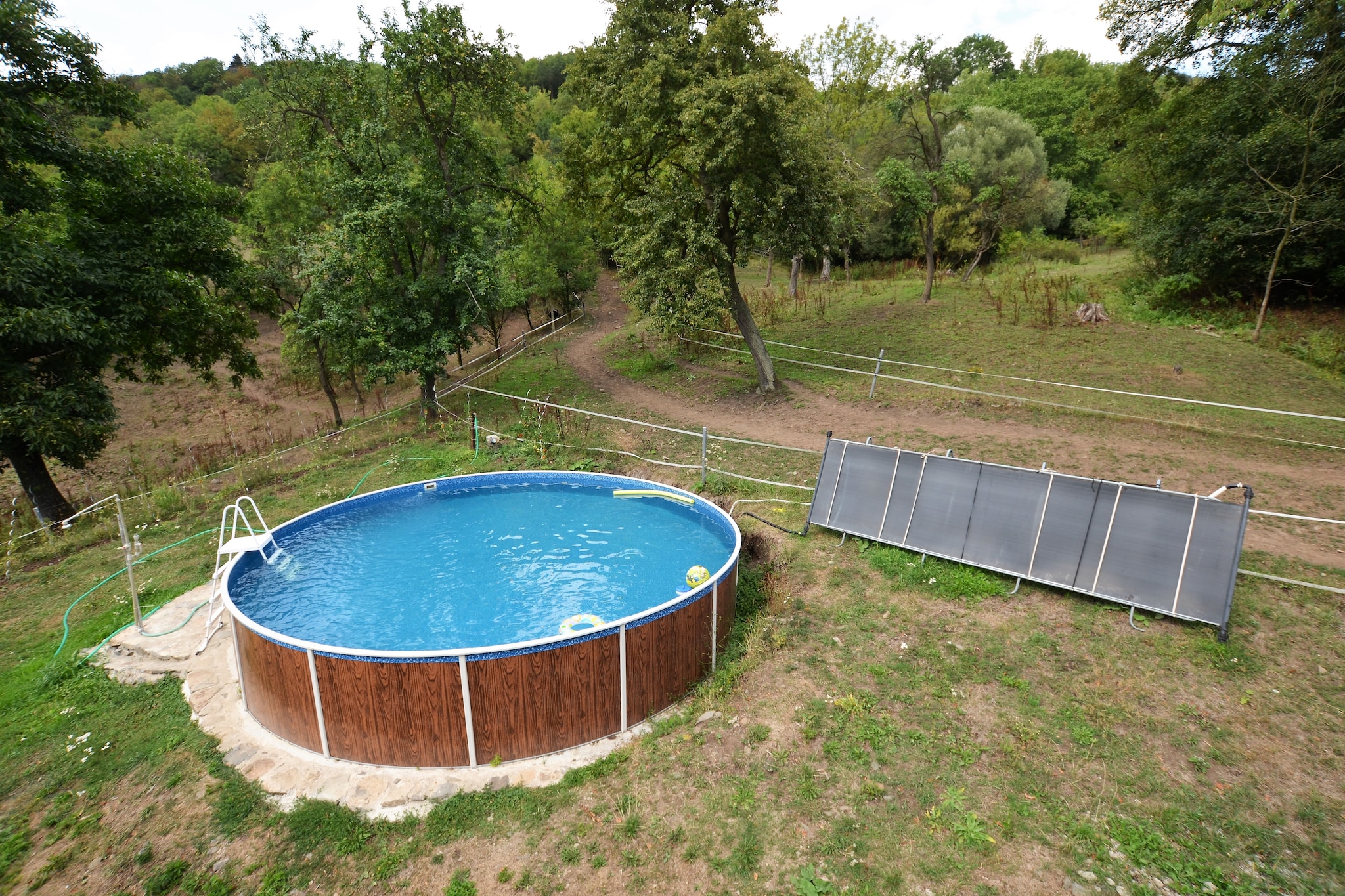 This spacious farmhouse, nestled near the forest, comfortably accommodates up to 9 guests across three bedrooms. Its warm, inviting living room features a decorative fireplace and ample seating for relaxing evenings together. The open kitchen and dining area make preparing and enjoying meals a delight, while the private terrace, garden furniture, barbecue, and swimming pool create the perfect setting for outdoor gatherings or quiet afternoons in nature.

Just 100 meters from the forest, this property offers immediate access to scenic walks and fresh air. Explore nearby Malecov, where shops and restaurants are within 7 km, and RÃ½deÄ and HlinnÃ¡ provide local dining just 4 km away. Outdoor enthusiasts can enjoy both indoor and outdoor public swimming pools 10 km from the house, or simply unwind in the tranquil surroundings of the garden and terrace.

For practical needs, the house is served by public transport 1 km away and LitomÄ›Å™ice, 10 km from the property, offers banks, doctors, and additional shopping. Parking is available on-site for ease of arrival and departure. Whether youâ€™re seeking a family getaway or a peaceful countryside escape, this farmhouse blends comfort, space, and access to the beauty of Central Bohemiaâ€™s forests.