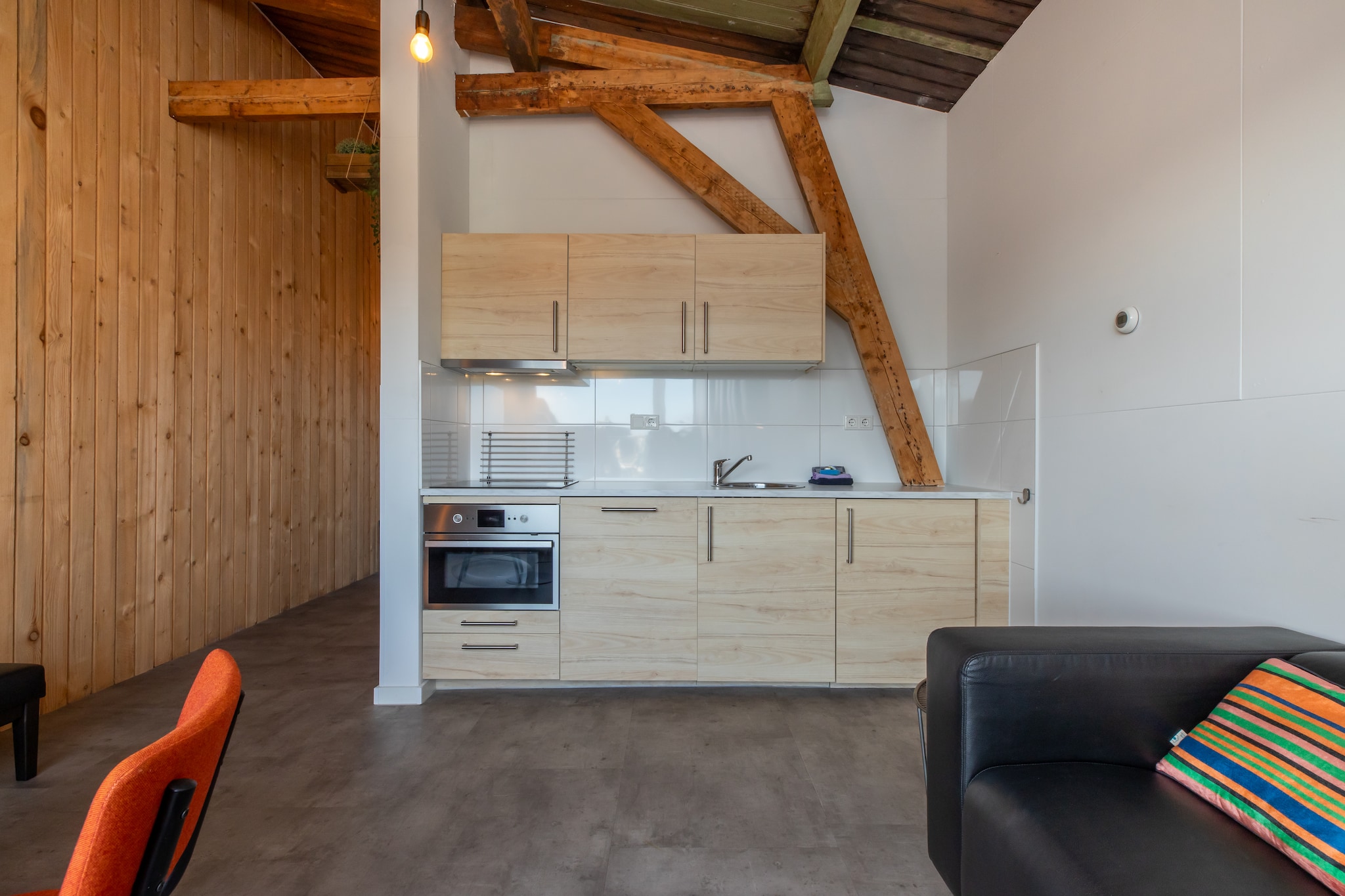 On the 1st floor: (Living room(TV(flatscreen, digital, dutch television channels, german television channels, international television channels), seating area), open kitchen(dining table(2 persons), hob(electric), electric kettle, hood, coffee machine, combination microwave, dishwasher, fridge-freezer), Bedroom with bathroom(single bed(boxspring), single bed(boxspring), shower, washbasin), toilet)\n\nparking, Charging post for electric cars