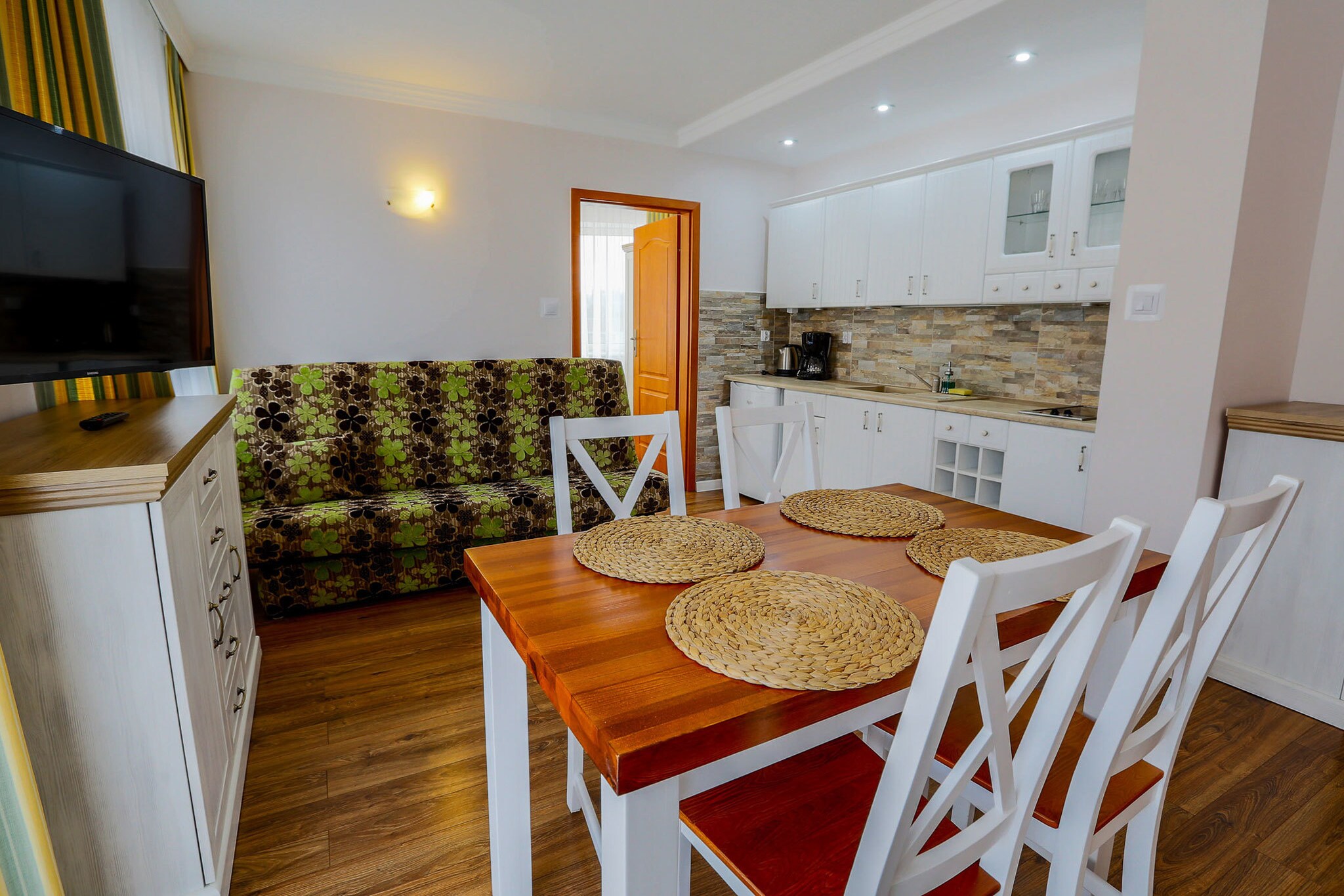 On the 4th floor: (open kitchen(electric kettle, boiling water tap, toaster, cooker, espresso machine, microwave, dishwasher, fridge), Living/bed room(double bed, double sofa bed, TV, dining table), bathroom(shower, washbasin, toilet))\n\nKitchenette(hob, electric kettle, fridge), Living/diningroom(double sofa bed, TV, dining table, seating area), bedroom(double bed), bathroom(shower, washbasin, toilet), garage, balcony, parking, lift