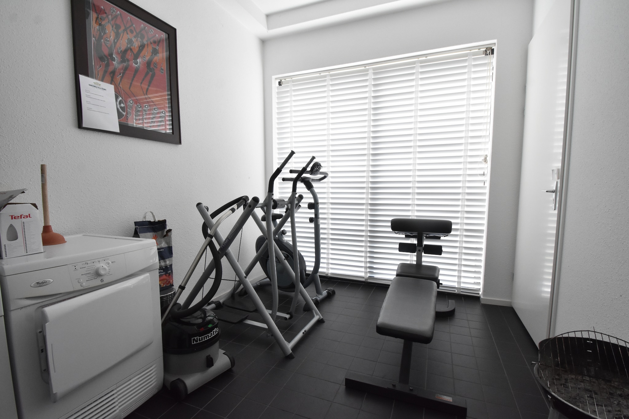 Ground floor: (hallway, Living room(TV, seating area), dining room(dining table), Kitchen(hob, electric kettle, hood, coffee machine, combination microwave, dishwasher, fridge), bedroom(double bed), bathroom(shower, sun shower, 2x washbasin, toilet), fitness room(washing machine, fitness equipment), BBQ)\n\nOn the 1st floor: (bedroom(single bed, double bed, balcony), bathroom(shower, washbasin, toilet))\n\njetty, tumble dryer, terrace, garden, garden furniture, lounge set