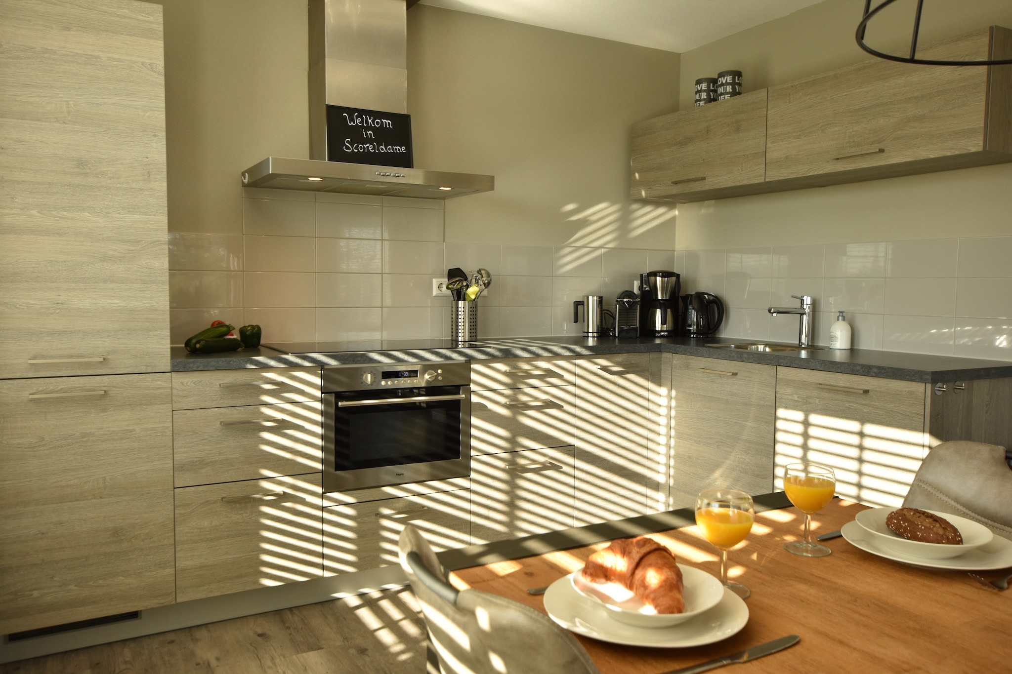 Ground floor: (Kitchen(electric kettle, toaster, cooker(4 ring stoves, induction), coffee machine(cups), coffee machine(filter), oven, microwave, dishwasher, fridge-freezer, Juicer, Blender, Hand blender), Kitchen(electric kettle, toaster, cooker(4 ring stoves, induction), coffee machine(cups), coffee machine(filter), oven, microwave, dishwasher, fridge-freezer, Hand blender), Living/diningroom(TV(flatscreen, digital, german television channels), dining table(14 persons), seating area, DVD player, radio, CD player), Living/diningroom(TV(flatscreen, german television channels), dining table(6 persons), seating area, DVD player, radio, CD player), bedroom(double bed(boxspring, two single duvets), TV(flatscreen, german television channels)), bathroom(shower(walk-in shower), 2x washbasin, toilet), bathroom(shower(walk-in shower), washbasin), toilet, carport, 2x garden doors, heating(floor heating), 2x BBQ(charcoal), parking, trampoline, parasol, sand pit, high chair, Swing set)\n\nOn the 1st floor: (bedroom(single bed(boxspring), single bed(boxspring), TV(flatscreen, german television channels)), bedroom(single bed(boxspring), single bed(boxspring), TV(flatscreen, german television channels)), bedroom(2x single bed(boxspring), TV(flatscreen, german television channels)), bedroom(2x single bed(boxspring), TV(flatscreen, german television channels)), bedroom(2x single bed(boxspring)), bedroom(2x single bed(boxspring), TV(flatscreen, german television channels)), bathroom(bath tub, shower(walk-in shower), washbasin, washbasin, toilet), bathroom(shower(walk-in shower), washbasin), toilet, 2x tumble dryer, infrared sauna, 2x washing machine, children\'s bed, stair gate)\n\nterrace(private), garden(private, partially fenced), garden furniture(14 persons), parking, trampoline(private), play equipment, children\'s bed, high chair, stair gate