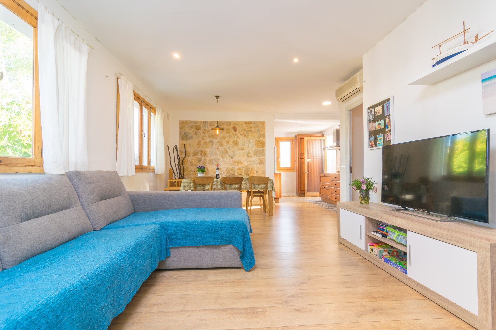 This wonderful chalet is placed between the two of the most beautiful lakes of this lively summer town and only 1 km away from the beach, so its is perfect for those who love the water around. The gravel garden is perfect to relax while having breakfast outdoors, chatting surrounded by peace with a glass of wine or enjoying a succulent barbecue. Then the swinging hammock under the porch will allow you to withdraw while reading a book or listening to some music. The property is fenced and there are neighbours around. 

While the exterior area features a traditional style, the inside surprises with its modernity and delicacy. When you enter you find a great living room with AC which leads to the dining and the kitchen. Here you find a comfortable sofa where you can sit and watch TV, listen to a CD or take a nap after a delicious banquet that you will enjoy on the dining table and cook on the ceramic top. The laundry room offers a  washing machine, an iron and an ironing board. There is 1 bathroom with a shower in the house as well as three bedrooms with a closet each. One has a single bed and the other two have two twin beds each. These two last have a fan and space for a baby cot and a high chair. There is an AC unit in the corridor to cool down the bedrooms. In addition, there are two radiators for the coldest days. Outside, you’ll find a toilet.

The area of Puerto de Alcudia is special thanks to its great tourist offer: water sports, night life, shops, restaurants, cafes, ice-cream parlours and much more, specially in the summer. It also boasts one of the largest and most beautiful beaches in the island thanks to its crystalline waters and white sand. However, if you feel like knowing small dream-like coves you can visit the ones of Sant Joan or La Victoria, the first of sand and the second of rocks and stones. In case you want to play golf you will find the course of Alcanada about 7.6 km away boasting impressive views to the bay and sea. The traditional street markets of Alcudia on Tuesdays and Sundays really are worth a visit too.

Please note that the wood stove cannot be used. Consult the advertiser for possible charges. Pets are not allowed. The holding of events is forbidden. There is exterior parking for 1 cars.  
Distances
Beach: 1 km - Puerto de Alcúdia
Airport: 62.8 km - Son Sant Joan
Golf course: 7.6 km - Alcanada Golf
Town: 0.01 km - Puerto de Alcúdia
Train station: 12.6 km - Sa Pobla
Bus stop: 4.1 km - Puerto de Alcúdia
Ferry: 4.3 km - Puerto de Alcúdia
Hospital: 24.5 km - Hospital Comarcal d'Inca
 Guests are kindly required to dispose of all rubbish and ensure the property is properly tidied before departure. Should this not be the case, a charge of €90 will be deducted from the security deposit. Tourist license: ETV/14180Single Rental Registry: ESFCTU0000070430000246480000000000000000000ETV/141802There's a mandatory tourist tax in Balearic Islands, called Ecotasa. All guests, except people under 16 years, have to pay this tax. The amount varies between 0.55€/night and guest during the low season and 2.2€/night and guest during  the high season .The tax is reduced by half from the 9th day for your stay.