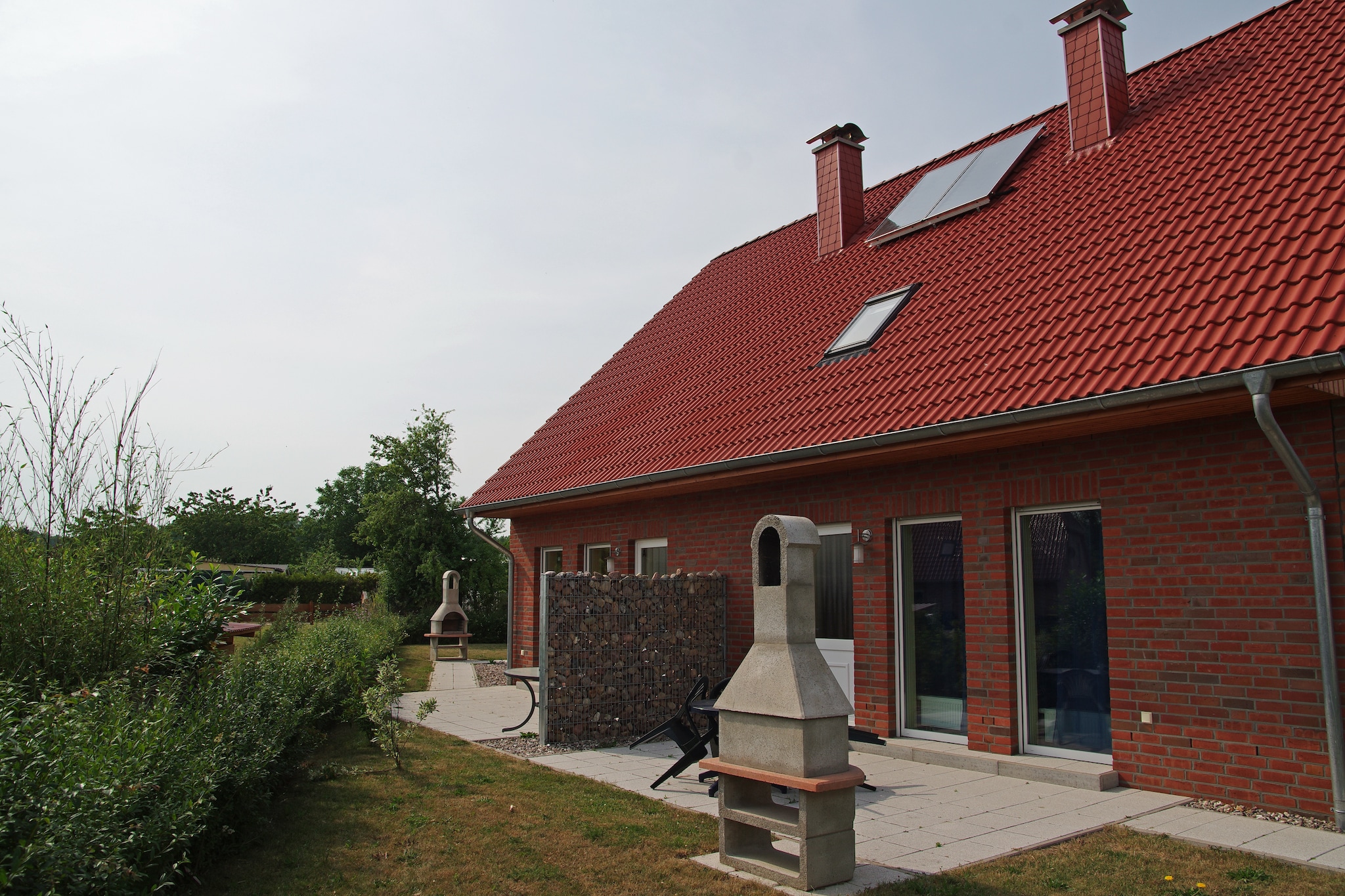 Situated in Zierow, this holiday home with 2 bedrooms, a sauna, grill, terrace, and fenced garden offers a wonderful stay for a family of 4 with children.

You can visit Wismar at 8 km and Boltenhagen at 17 km during the stay. Sports lovers can have fun trying activities like horse riding, golf, and water sports. Take your kids and head to the beach at 500 m. It is fun for the whole family. All basic facilities are within reach with restaurants at 500 m and a supermarket at 2 km.

The fireplace will keep you warm as you relax in the living-dining room. The bathroom is luxurious with a sauna and walk-in shower. During the cold evenings, you can light the outdoor fireplace and relax on the terrace with a grill. Enjoy the fresh air from the furnished garden. Cot, high chair, and parking are also arranged.