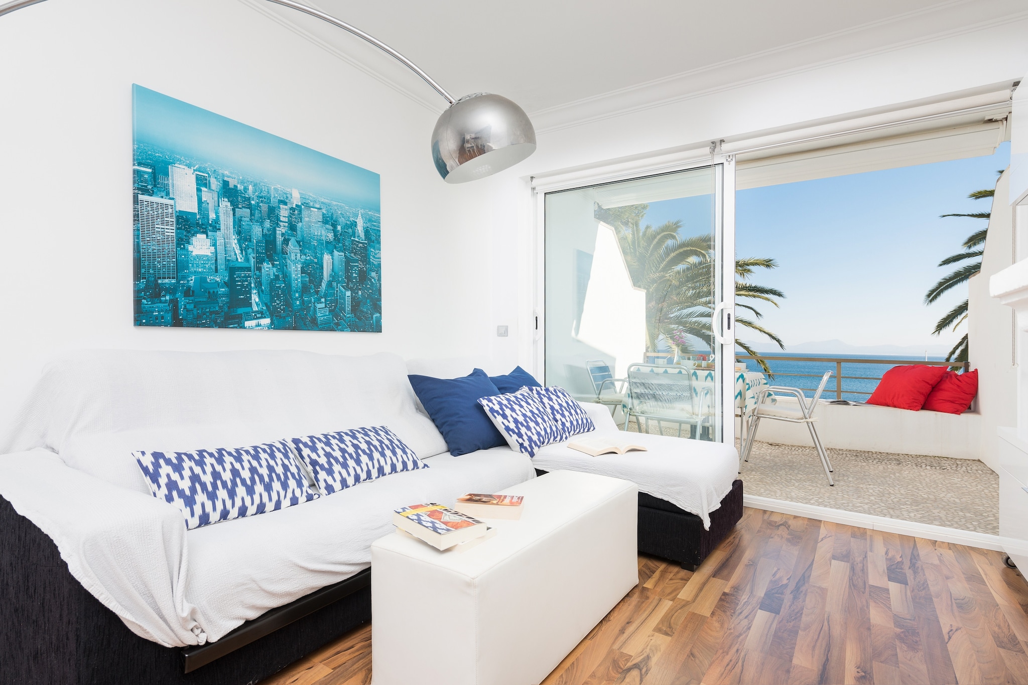 Located in the sea front in Alcanada, this wonderful home will make our guests almost sale the crystalline waters from the cosy and beautiful terrace. Just imagine yourselves every morning by a succulent breakfast next to the sea, listening to the sound of the waves and revelling in the scent of the sea breeze. The apartment is placed between the street and the hill so you can descend right to the beach from the communal garden going down some steps. When you come back, you can use the exterior shower to wash the salt off before going up for lunch or dinner.

The inside emanates modernity with a beautiful beach touch, specially the spacious living - dining - kitchen. It is perfect to spend time together while cooking on the ceramic hob, setting the table or watching the satellite TV while eating, or relaxing on the sofa. In the coldest days you can light the fire. Of course, you will find a washing machine, iron and ironing board. There is a shower bathroom for the whole accommodation and in order to rest, there are two bedrooms, both with a wardrobe and air conditioning. One has a double bed and the other has a single bed. We will provide you a baby cot and a high chair in case you need any of them. 

Alcanada is a quiet neighbourhood mainly inhabited by locals that go there to spend their family vacation. In fact, during the summer the area is full of life and it offers all needed services like supermarket, bars and traditional food restaurants. But the best of it all is that beach is just a few steps away. This quiet beach has some sand but lots of pebbles and seaweed. You will be able to swim to the islet in front of it, where you will find a lighthouse that makes this area one of the most beautiful ones in the island. And if you like playing golf, this is the perfect place since one of the best courses in the island is right there boasting wonderful views to the sea, the club of Alcanada. Consult the advertiser for possible charges. Pets are not allowed. The holding of events is forbidden. There is exterior parking for 1 cars.  
Distances
Beach: 0.1 km - Alcanada
Airport: 66.5 km - Son Sant Joan
Golf course: 0.7 km - Golf d'Alcanada
Town: 1.8 km - Puerto de Alcúdia
Train station: 19 km - Sa Pobla
Bus stop: 0.8 km - Alcanada
Ferry: 1.2 km - Puerto de Alcúdia
Hospital: 28.3 km - Hospital Comarcal d'Inca
Tourist license: ETVPL/14791Single Rental Registry: ESFCTU00000704300004697800000000000000000ETVPL/147918There's a mandatory tourist tax in Balearic Islands, called Ecotasa. All guests, except people under 16 years, have to pay this tax. The amount varies between 0.55€/night and guest during the low season and 2.2€/night and guest during  the high season .The tax is reduced by half from the 9th day for your stay. Homerti - Central de Reservas CR/33
