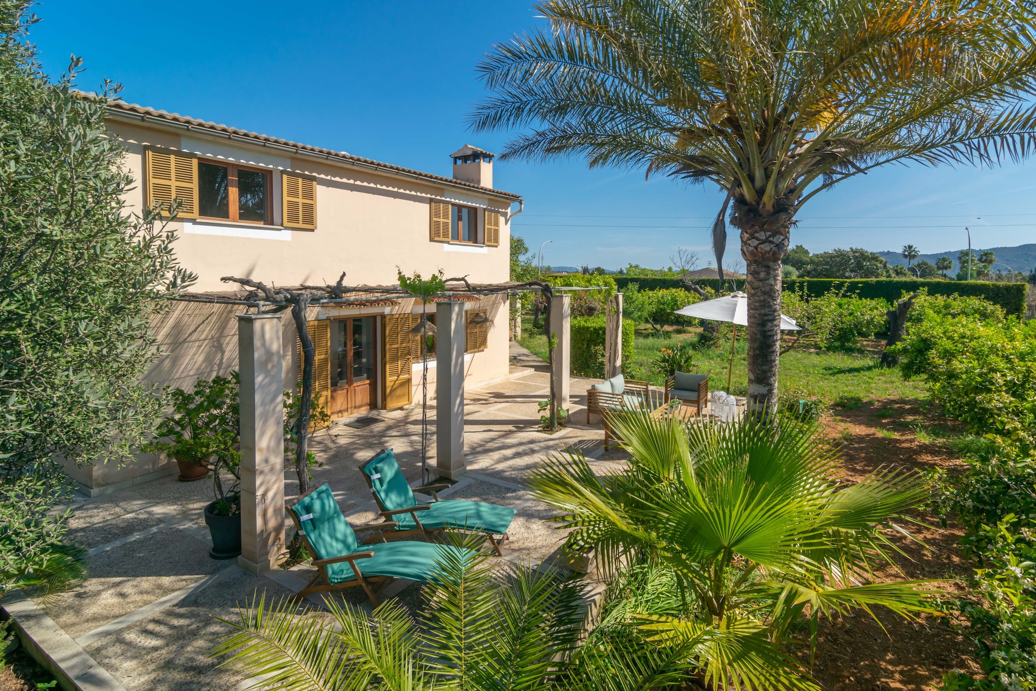 This cosy and great villa invites to relax thanks to the peace that the fields offer. The lovely exterior area that includes fruit trees, the furnished terrace with a barbecue and a natural pond with fishes, and the patio in front of the house also perfectly furnished with two sun loungers, tables with chairs to enjoy your appetisers alfresco, will make you fully enjoy your stay. The property is fenced and there are neighbours around.
The house has two floors. Upon entering, you will find a spacious and comfortable living-dining room with air conditioning, ideal for dining together and then chatting or relaxing while watching satellite TV. The kitchen is independent and offers a gas stove, oven, and a beautiful Mallorcan style, among many other features. There are two bathrooms with showers on this same floor that serve the entire house, although one of them is located outside and accessed through the garage. For resting, there are three bedrooms, two on the main floor with wardrobes, one with a double bed and the other with a single bed. Then, there is the third bedroom upstairs with two single beds and a sitting area with a TV (without satellite). There is a washing machine on the terrace, as well as an iron and ironing board. A crib and a high chair are also available.
Inca is a lovely and familiar city basically in the centre of the island offering all needed services for an independent stay such as bars, Majorcan restaurants, shops, supermarkets, etc. It also offers an easy access to any point of the island in a reasonable amount of time. You cannot miss its street market on Thursday morning that has been taking place for centuries and is the perfect place to buy local products. The nearest beach is Playa de Muro about 27.3 km away which is characterised by its crystal-clear water and fine sand. Note: This accommodation is intended for families and guests over 30 years old who are looking for a peaceful stay. Bookings for parties or celebrations are not accepted. A copy of the identification document of all guests will be required to confirm the reservation. Consult the advertiser for possible charges. Pets are not allowed. The holding of events is forbidden. There is exterior parking for 3 cars.
Distances
Beach: 27.3 km - Platges de Muro
Airport: 37.3 km - Son Sant Joan
Golf course: 29.5 km - Golf Alcanada
Town: 1.3 km - Inca
Train station: 2.5 km - Inca
Bus stop: 2 km - Inca
Ferry: 28.5 km - Puerto de Alcúdia
Hospital: 2.8 km - Hospital Comarcal d'Inca
Tourist license: ETV/12466Single Rental Registry: ESFCTU0000070110002977820000000000000000000ETV/124665There's a mandatory tourist tax in Balearic Islands, called Ecotasa. All guests, except people under 16 years, have to pay this tax. The amount varies between 0.55€/night and guest during the low season and 2.2€/night and guest during the high season .The tax is reduced by half from the 9th day for your stay.