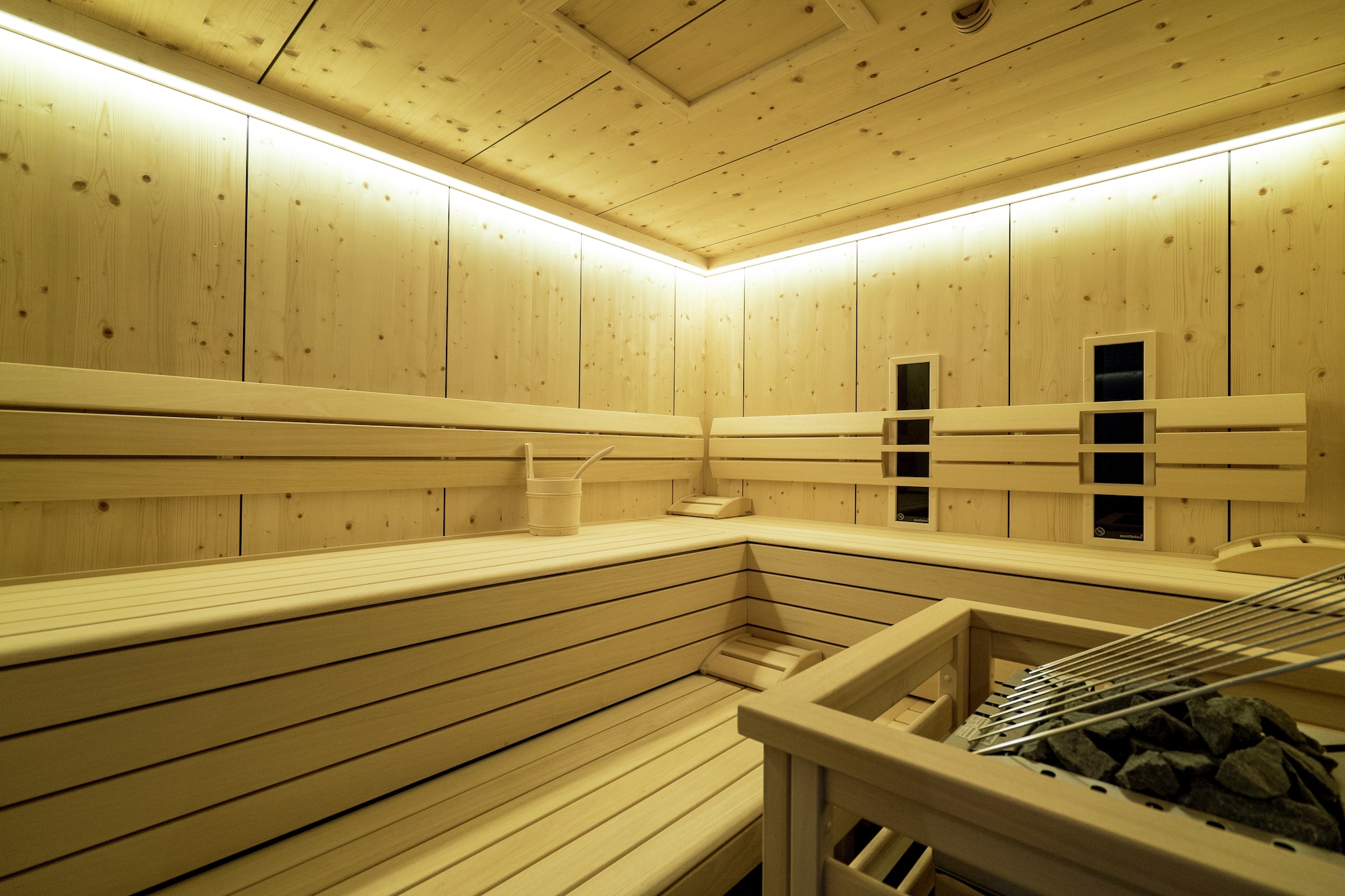 Ground floor: (Living room(double sofa bed, TV, dining table, balcony), open kitchen(cooker, coffee machine, oven, microwave, dishwasher, fridge-freezer), bedroom(double bed, TV, balcony), Bedroom with bathroom(double bed, TV, shower, washbasin, toilet, balcony), bathroom(shower, sauna, 2x washbasin), toilet)\n\nski storage(shared with other guests)(ski boot heaters), parking, parking, parking, Essentials(Towels, bed sheets, soap and toilet paper)