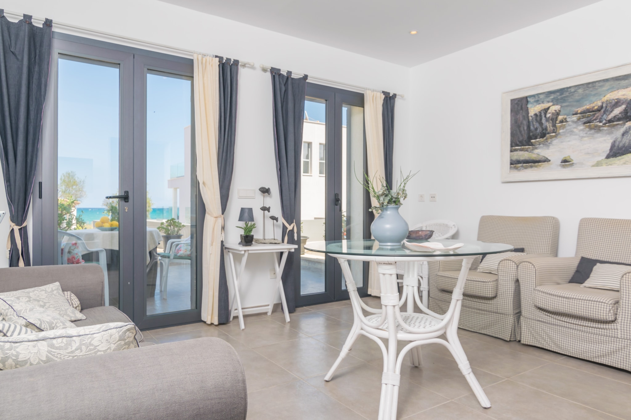 Enjoy a delicious breakfast daily, while you can look at sea as well as you can feel its fresh and gentle breeze, before you get ready to have a swim in its atonishing waters. Once you come back home, there is an outdoor shower where you are going to be able to take the seasalt out of your bodies and, in addition to this, you can also enjoy of the terrace as well as the indoor terrace, which is also furnished perfectly to take a glass of wine and, then, to have dinner.

The property is distributed over two floors. On the main floor you have a spacious living room, with sea views, where you will enjoy chatting together or watching satellite TV. For more comfort, this room has a cosy wood-burning cooker, ideal for the cooler nights. Next, you enter the kitchen-dining room, equipped with a gas hob, oven and everything you need to cook as comfortable as at home. From here you go out onto the interior terrace where you will find the main bathroom of the house, which has a shower, and some exterior stairs that give access to the upper floor. Here you will find a second living room with television, perfect if one of our guests needs a break reading a book. In this room you will find the cot. Then there is a toilet and two bedrooms, both with wardrobe and air conditioning. One has two single beds and the other has a double bed. The laundry is downstairs in a separate room where, if you are staying with children, you can do the laundry while they have fun painting or playing.

Son Serra de Marina is an ideal coastal area for those people who want both sea and peace during their holidays. The coast is mostly rocky with crystal-clear waters and, at the end of it, there is such a beautiful sandy beach. There is a restaurant that serves their customers good meals with ocean views, but if you look for some other restaurants, bars, other facilities or even other beaches, then you just need to drive within minutes to Can Picafort or to Puerto de Alcúdia, places that are much more bustling.

Firewood is not included. Consult the advertiser for possible charges. Pets are not allowed. The holding of events is forbidden. 
Distances
Beach: 0.20 km - Son Serra de Marina
Airport: 63.3 km - Son Sant Joan
Golf course: 26 km - Alcanada Golf
Town: 0.001 km - Son Serra de Marina
Train station: 25.6 km - Estación de Sa Pobla
Bus stop: 0.20 km - C/ Joan Frontera, Son Serra de Marina
Ferry: 23.1 km - Puerto de Alcúdia
Hospital: 30 km - Hospital Comarcal de Inca
 Guests are kindly required to dispose of all rubbish and ensure the property is properly tidied before departure. Should this not be the case, a charge of €90 will be deducted from the security deposit. Tourist license: ETV/12218Single Rental Registry: ESFCTU0000070110007465870000000000000000000ETV/122182There's a mandatory tourist tax in Balearic Islands, called Ecotasa. All guests, except people under 16 years, have to pay this tax. The amount varies between 0.55€/night and guest during the low season and 2.2€/night and guest during  the high season .The tax is reduced by half from the 9th day for your stay.