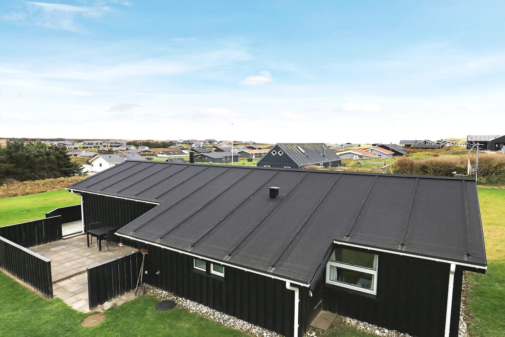 Internet Access DSL, open kitchen(cooker(electric), hood, coffee machine, dishwasher, fridge-freezer), Living/bed room(TV(german television channels, danish TV channels (DR1 and TV2)), CD player, stereo unit, high chair), bedroom(double bed, cot), bedroom(2x single bed), bathroom(floor heating)(bathtub or shower, washbasin, toilet, washing machine), heating(electric), terrace, terrace(roofed), BBQ, play equipment, air to air heatpump