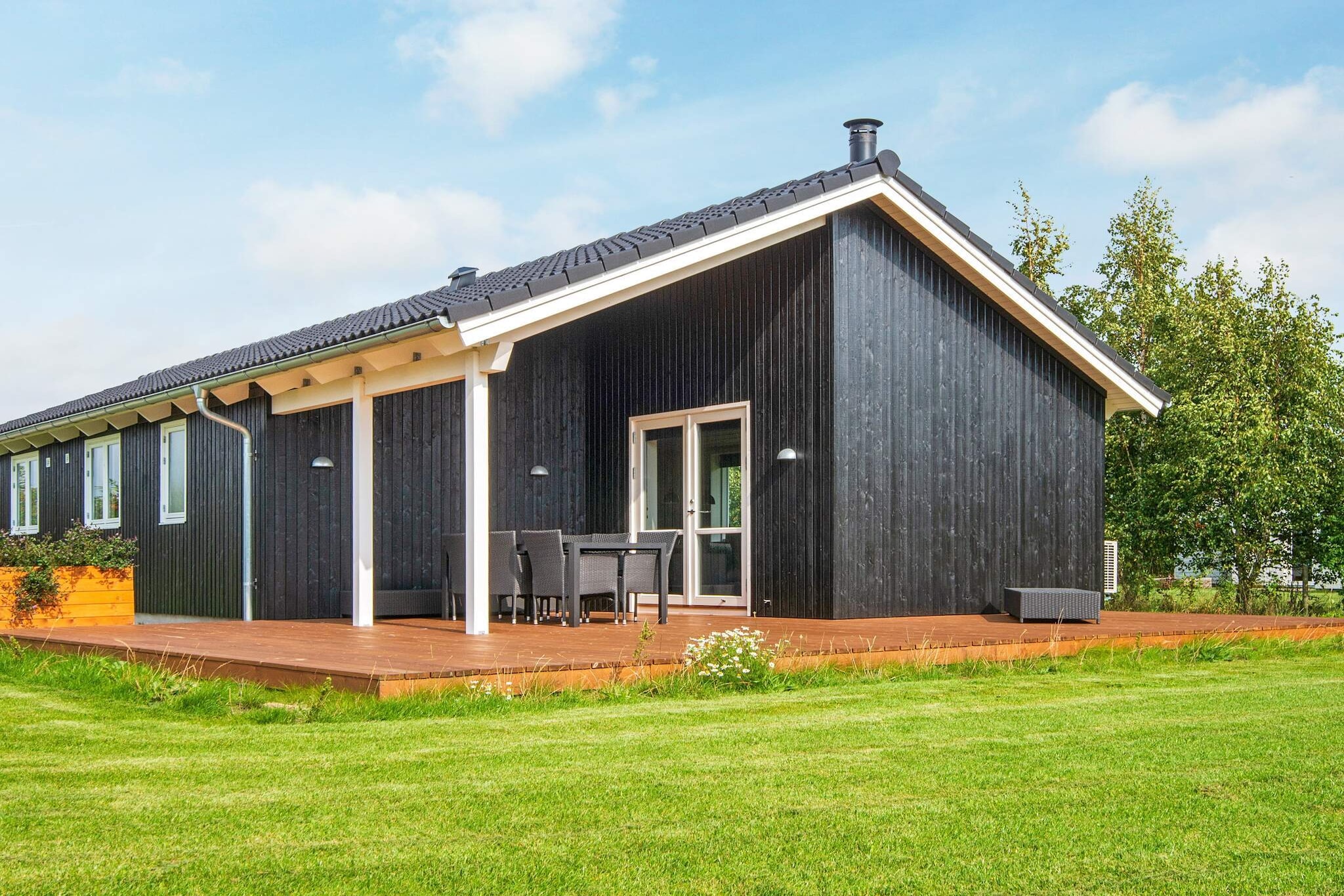 In this well-appointed holiday home from 2019 located by Skovmose you will find all the facilities for a relaxing holiday. The cottage is furnished with a large kitchen-dining room where you will experience spaciousness combined with a modern decor and Danish cottage style with i.a. stone wall by wood stove. There are three bedrooms as well as a large loft area, which will surely be chosen by the children for sleeping or living area. The loft is also built with a reasonable standing height. If you need relaxation and recreation, you can enjoy the beautiful bathtub, find peace from a busy everyday life. The large terrace area consists partly of a covered area and a large open area. Here, the outdoor life can be lived all day long with a nice selection of garden furniture, where there is also thought of solar carts etc. Not for rent to youth groups.