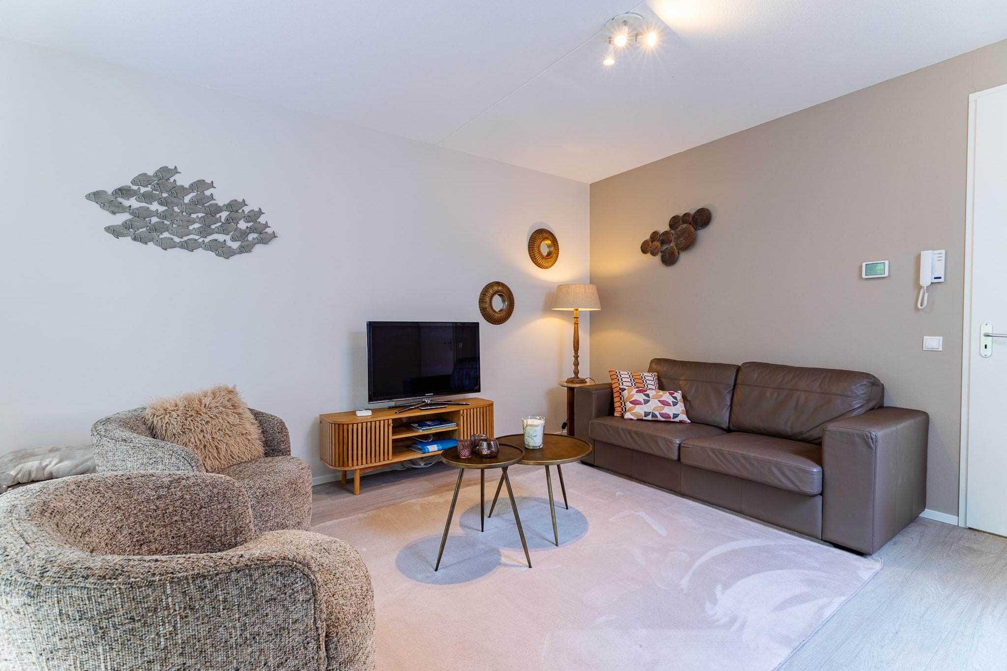 Tucked against the dunes of Koudekerke-Dishoek, where the air tastes of salt and the beach is only a short stroll away, this elegant apartment offers a peaceful coastal retreat wrapped in greenery. Here, days unfold gently mornings begin with soft light over the dunes, afternoons drift between sea and terrace, and evenings invite you to slow down and simply enjoy the calm. It’s a place designed for switching off, without ever feeling far from the rhythm of the coast.

Inside, the apartment feels spacious, warm and inviting. The bright living area is centred around a cosy fireplace, perfect for unwinding after a day outdoors, while the open kitchen encourages shared meals and long conversations. Large doors lead to a balcony with dune views, extending your living space into the fresh sea air. Three comfortable bedrooms are thoughtfully arranged for rest and privacy, complemented by a stylish bathroom where both quick refreshes and long, relaxing baths feel equally at home.

Above it all, a generous rooftop terrace opens up to sky and sunshine, an ideal spot for lazy afternoons, evening drinks or simply enjoying the quiet beauty of the surroundings. Practical comforts such as a washing machine, dryer, private storage and a parking space with electric charging ensure an effortless stay. Smoke-free, pet-free and welcoming for families, this apartment is a serene base for beach days, cycling adventures and year-round escapes along the Zeeland coast.
