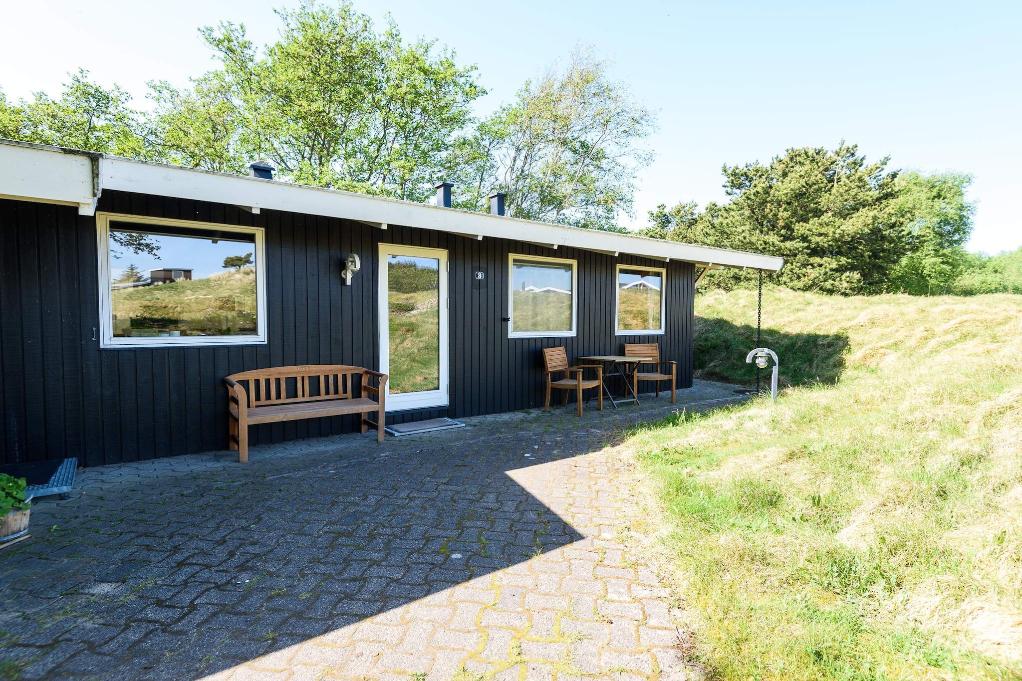 This is a very well-maintained, attractive and charming holiday home with a bright and welcoming interior. The holiday home in Rindby on Fanø was renovated in 2011, including an extended living room, a functional kitchen that is open to the lovely and bright living room with a wood-burning stove and direct access to lovely open and covered terraces. There are three good and charming bedrooms with room for six people and a lovely bathroom. The holiday home is in tip-top condition and enjoys a completely undisturbed location on a magnificent, animal-rich and lovely enclosed natural plot. The forest begins in the back garden, providing a fantastic sense of nature and wildlife right up to the terrace. A truly lovely holiday home where you can enjoy peace, quiet and wonderful moments on Fanø on the west coast! Free final cleaning!A refundable deposit might be charged closer to your check-in date. The security deposit ensures a smooth stay and covers any additional services or consumption charges.This deposit covers utilities consumed during your stay and any additional services that may be taken.The final amount will be adjusted based on actual meter readings, actual usage of extra services, and any remaining balance will be refunded within 21 days after checkout.This deposit simply acts as a prepayment for charges that  you would anyways pay for, ensuring a seamless stay and check-out experience.