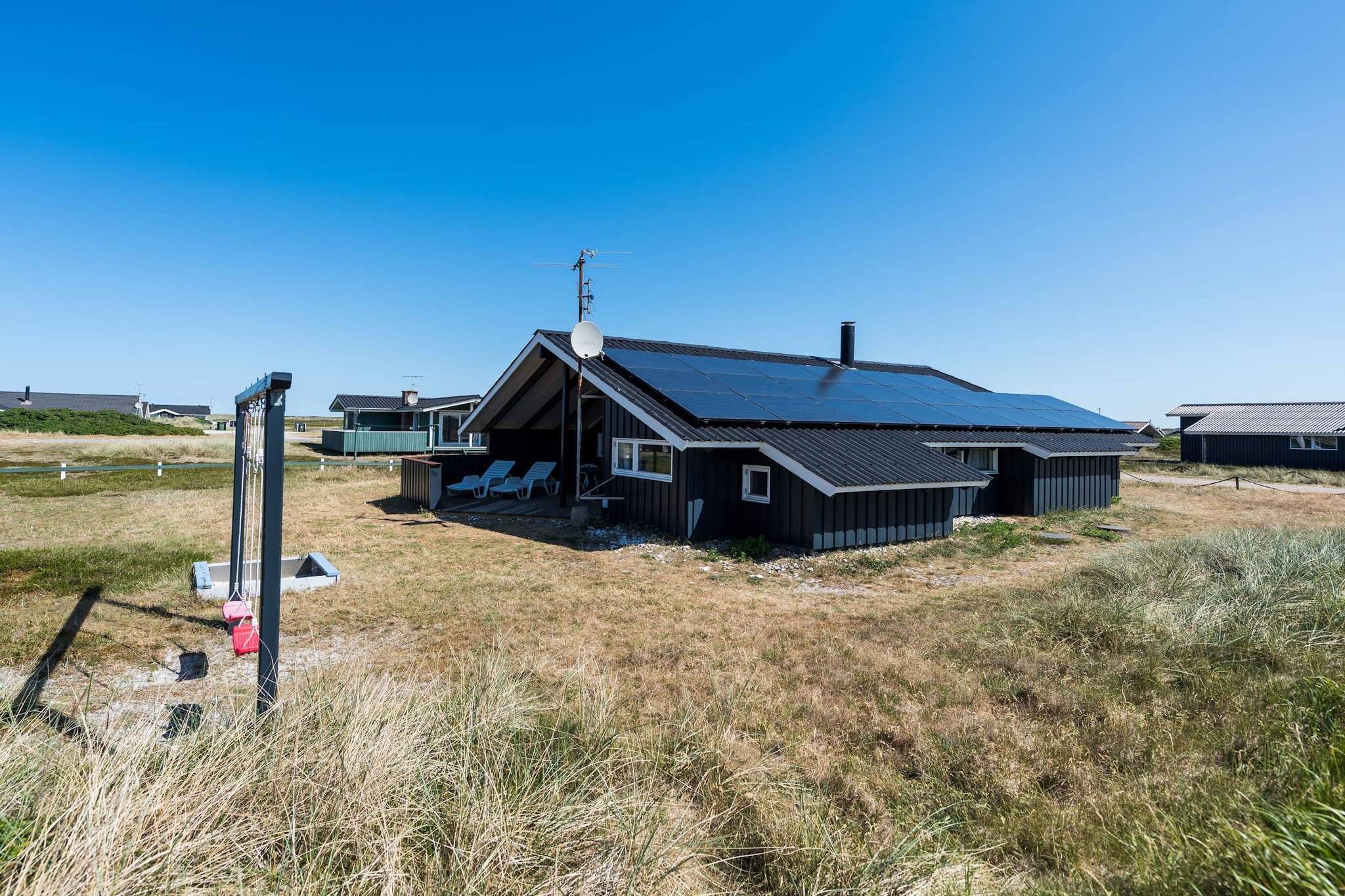 open kitchen(cooker(electric), coffee machine, microwave, dishwasher, fridge(+ freezer), freezer(1-59L)), Living/bed room(2x single folding bed, DVD player, radio, CD player, children\'s bed, high chair), bedroom(double bed), bedroom(double bed), bedroom(single bed), bathroom(floor heating), Bubble bath(indoor, 2 persons), sauna(indoor, heated), washing machine, heating(electric), terrace, terrace(roofed), garden furniture, BBQ, play equipment, children\'s bed, high chair, air to air heatpump