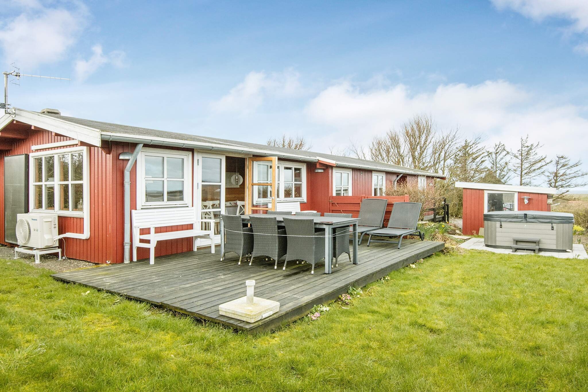 Well-located holiday home, renovated in 2019 and 2020, with a large outdoor hot tub for 5 people with panoramic views of the Limfjord both inside and out. It is only approx. 350 meters to the Limfjord with a child-friendly beach and a jetty, where you can catch crabs or fish, among other things. The holiday home is an energy-friendly house with a heat pump and thus the possibility of low consumption. There is a separate kitchen equipped with, among other things, ceramic hobs, separate oven with grill and fridge/freezer with a freezing capacity of 60 liters. Lovely bright living room with pitched ceiling and large windows, where the panoramic view of the fjord can be enjoyed to perfection and with access to a large wooden terrace with sun loungers, good garden furniture and a barbecue, where you can enjoy dinner while the sun sets over the fjord. The living room also offers comfortable furniture, a flat-screen TV with international channels and a Chromecast, where you can stream your own TV services. There is a wood-burning stove for a cool summer evening or an autumn evening with rain and debris. Bathroom with bathing environment, shower and washer/dryer. In addition, a guest bathroom with toilet and bathing environment. The house has three bedrooms, two of which have double beds and 1 room with bunk beds for 2 people. The cottage has a new roof and driveway in 2020. The garden is being renovated in autumn 2020 and spring 2021. This house is suitable for all seasons, not least because of the panoramic view of the Limfjord both inside and out, but also because of the large outdoor hot tub, which can be enjoyed in all kinds of weather. Not rented to youth groups.A refundable deposit might be charged closer to your check-in date. The security deposit ensures a smooth stay and covers any additional services or consumption charges.This deposit covers utilities consumed during your stay and any additional services that may be taken.The final amount will be adjusted based on actual meter readings, actual usage of extra services, and any remaining balance will be refunded within 21 days after checkout.This deposit simply acts as a prepayment for charges that  you would anyways pay for, ensuring a seamless stay and check-out experience.